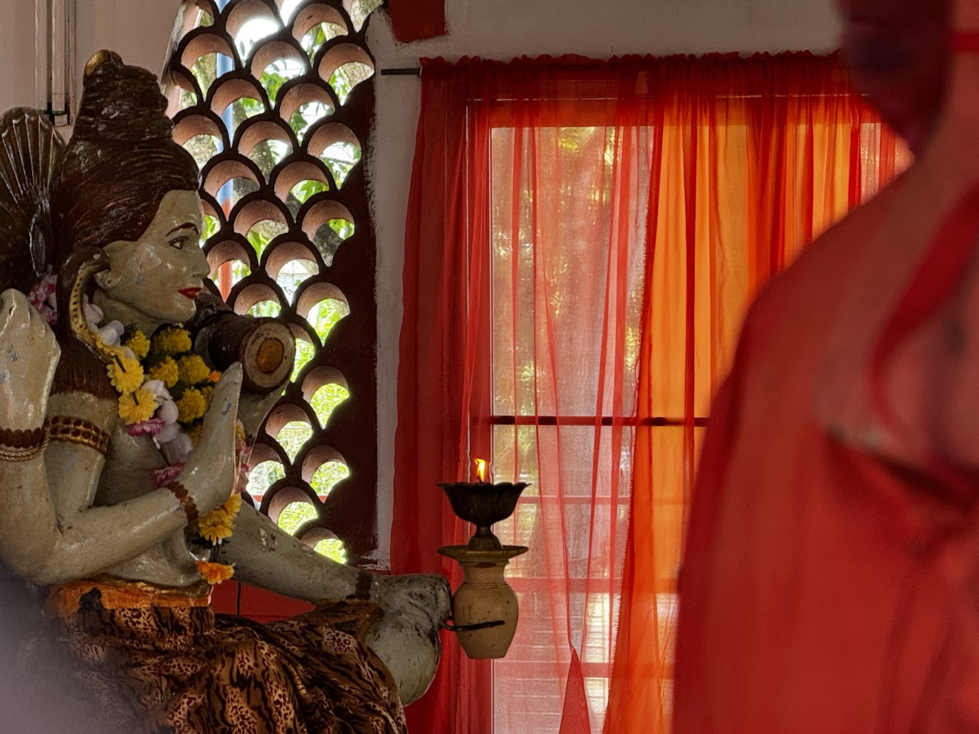 The temple deities, seen here through a window, sit in an empty and locked-tight hall.