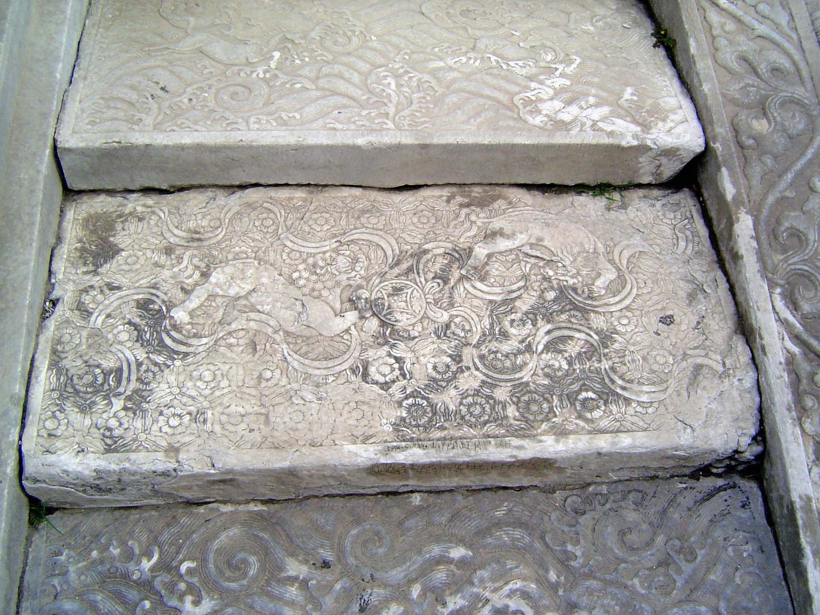 The flanking steps are carved, too, in this case with lions and horses.