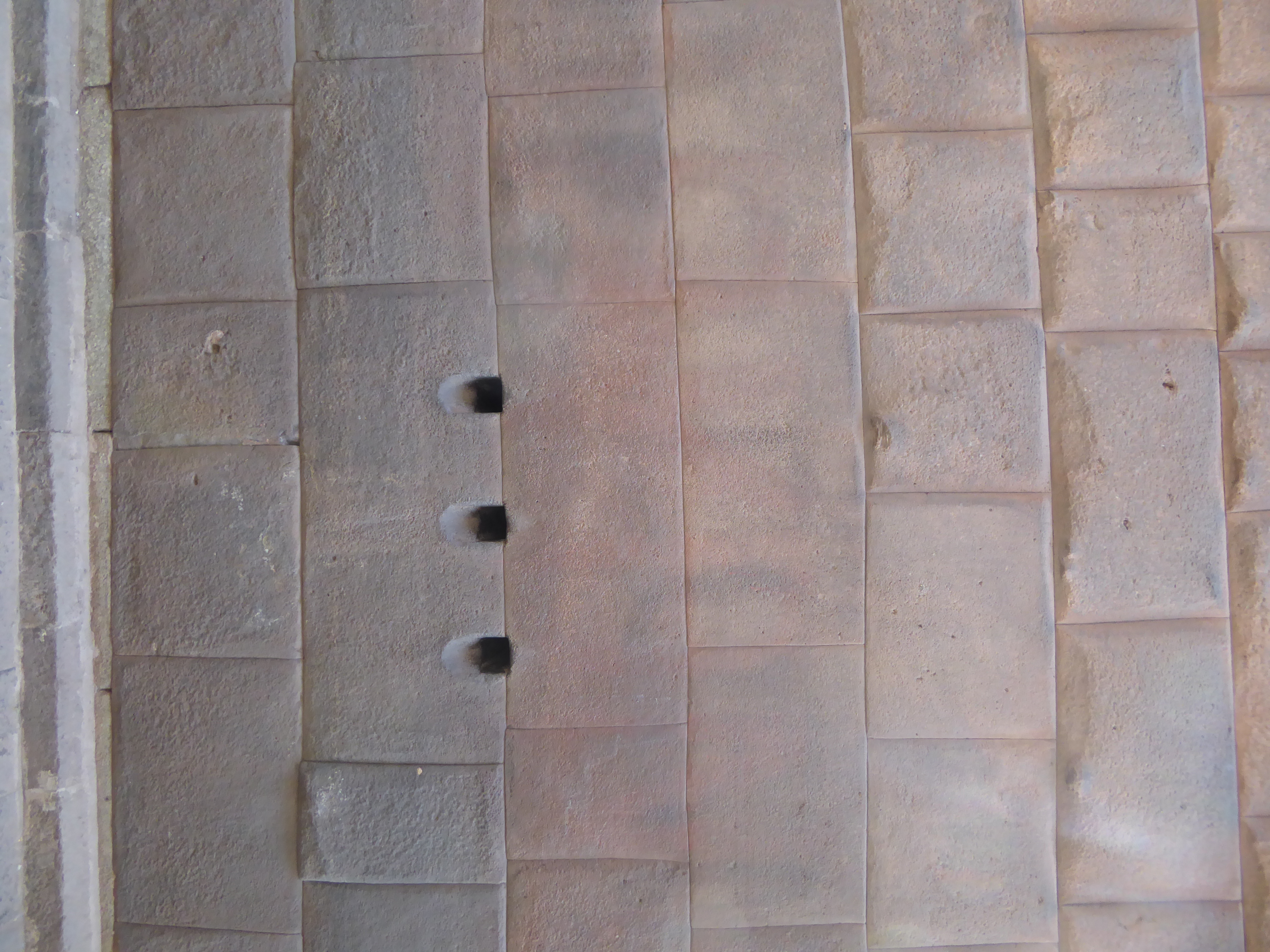 It's one of three that penetrate the wall, which is a single block thick. Here, on the outside of the building, is the other end of those ho