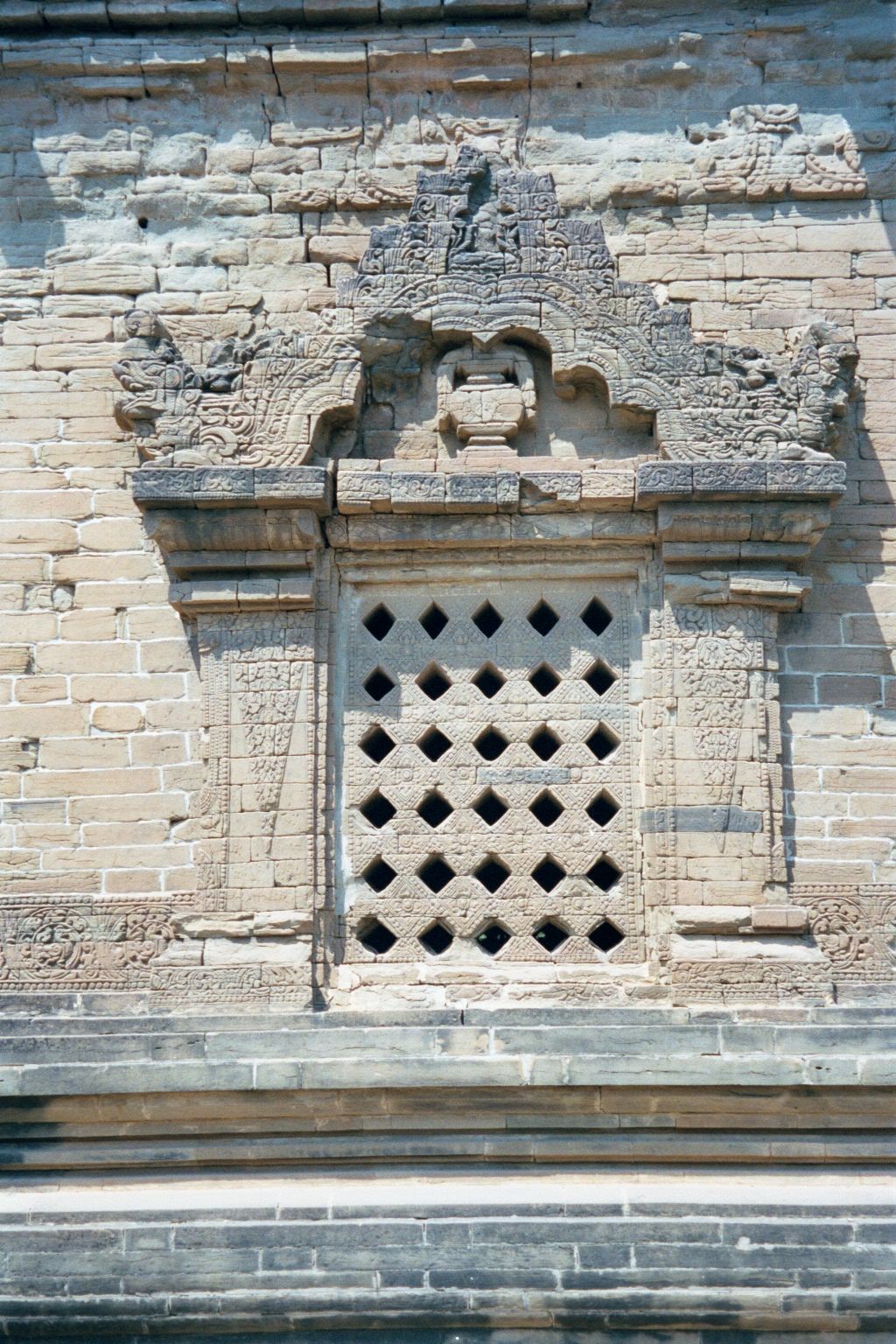 The windows are perforated to keep light levels low. The V-shaped ornament on the sides of the window is characteristic of Pagan and appears