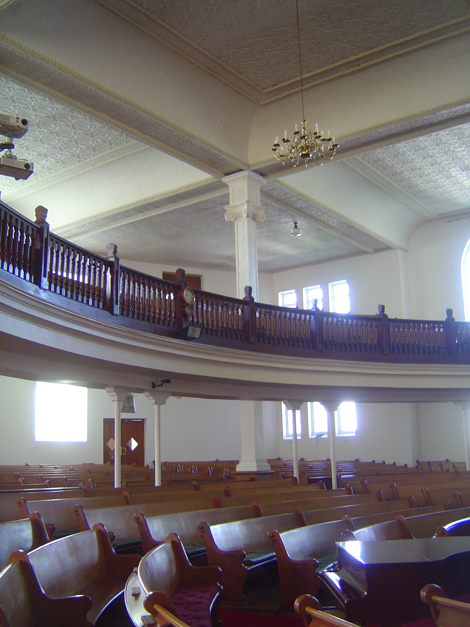 The interior is a square with elegantly curved pews. Getting inside seems to require the equivalent of an act of congress.