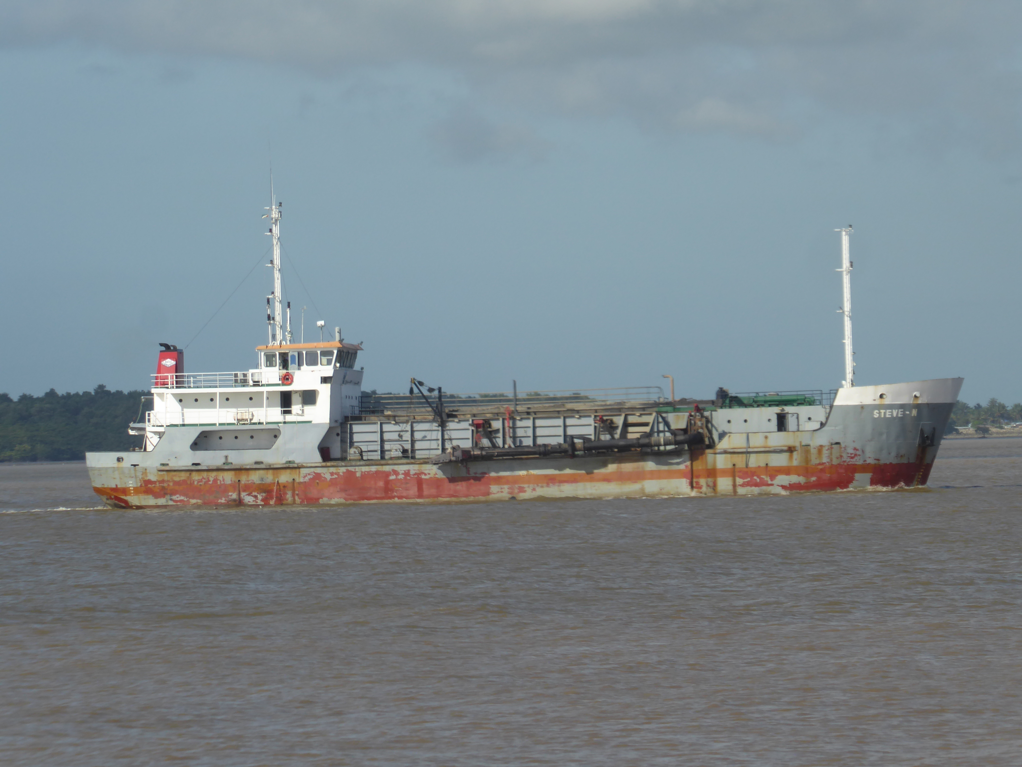 The ship's neighbor was a dredger built in 1983. What's to dredge? The Demerara is navigable for 60 miles or more to Linden, a bauxite-minin