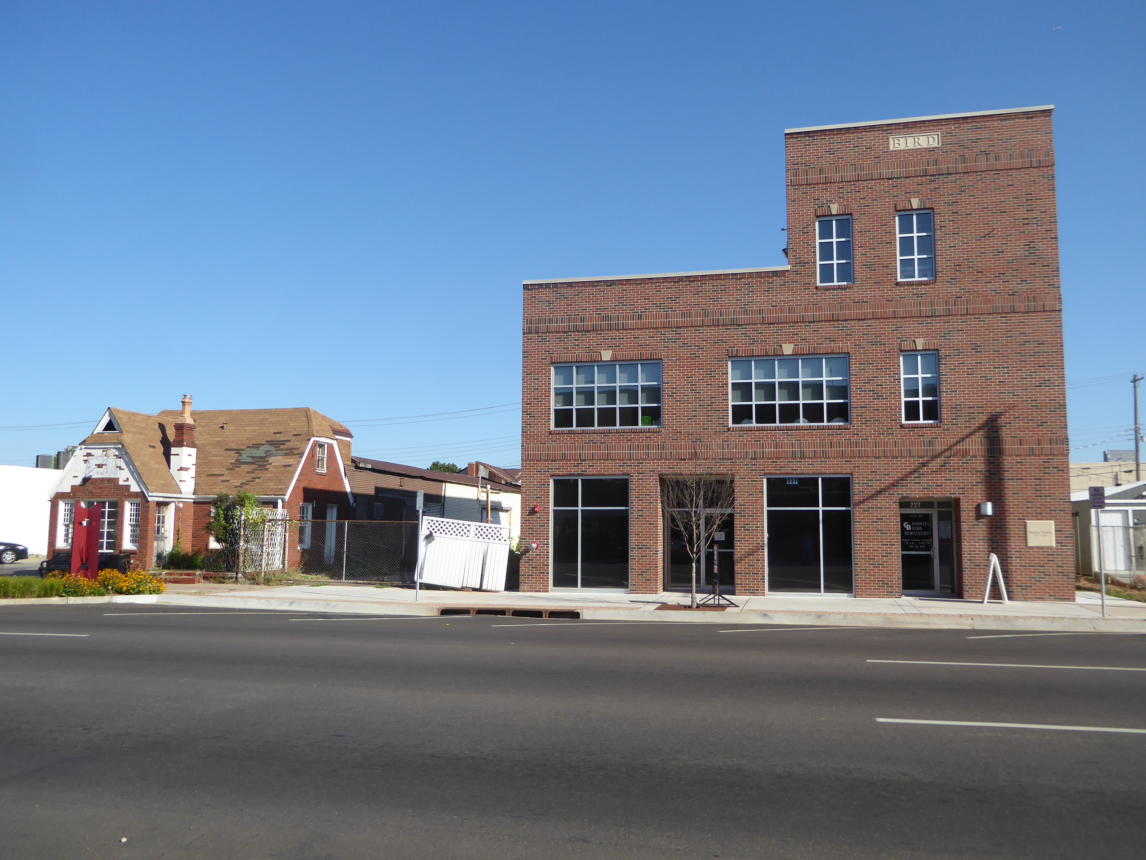 A brave dentist has built an office building and is looking for customers. His name's up top, like in the old days.