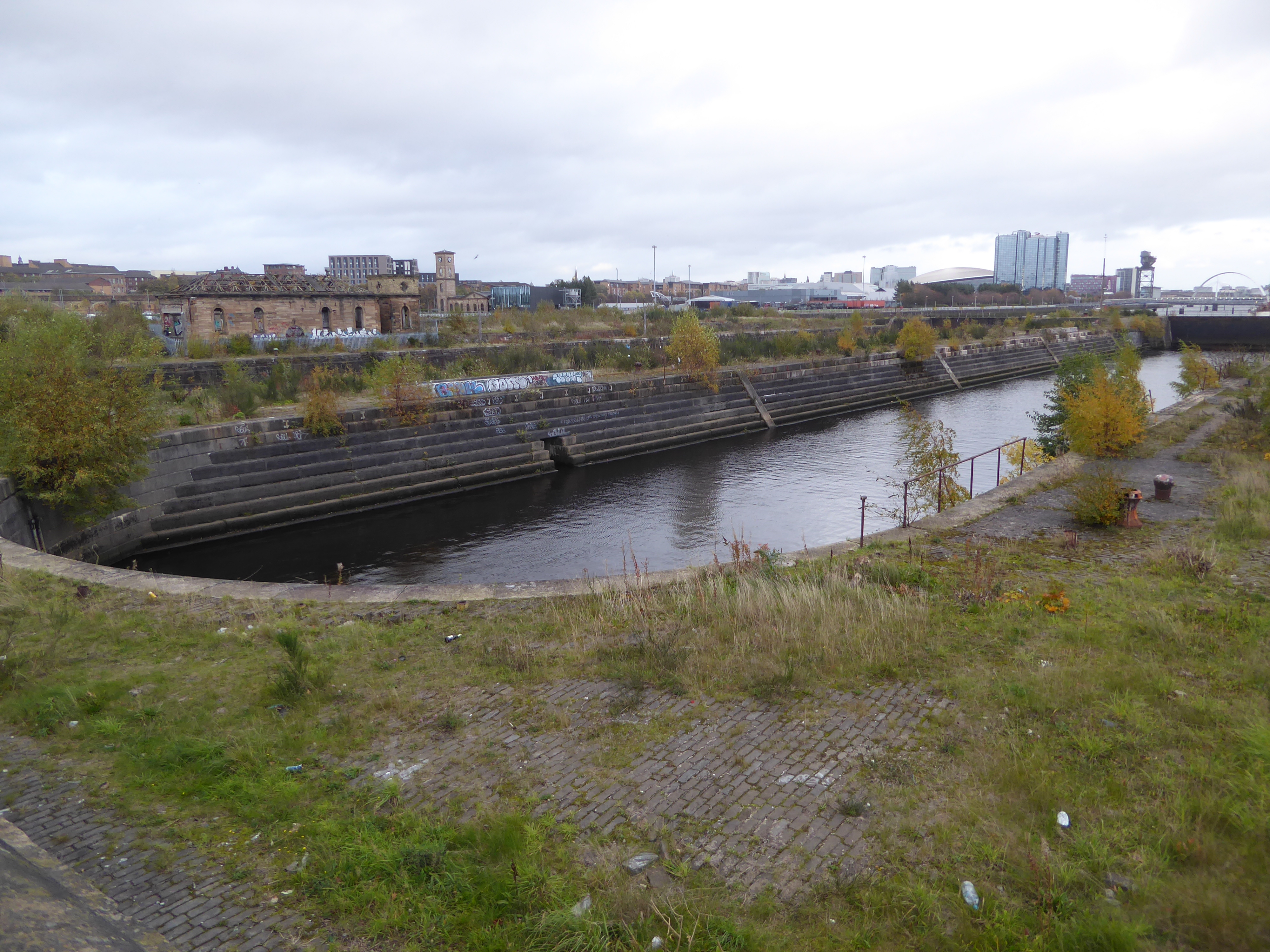 Another view of the graving docks. Beyond the gate at the far end there's an arch; it's a bridge over the river.