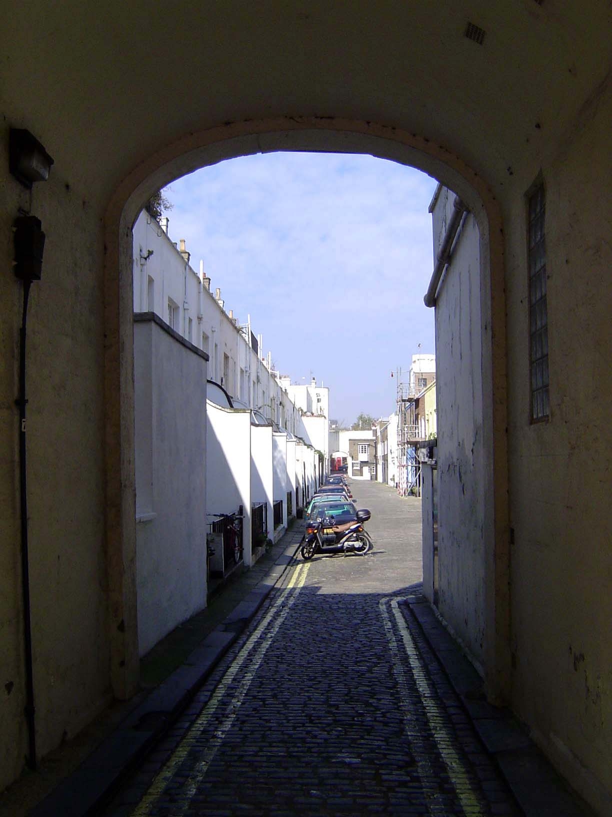 Behind the houses a tunnel leads to the mews.