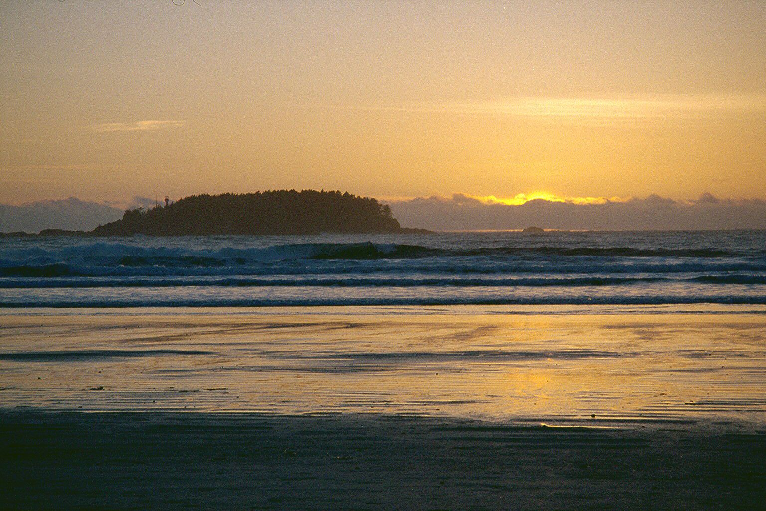 The sea beyond the surf will soon turn in the darkness to a breathing, pulsating creature, rising and falling with the passing of each wave.