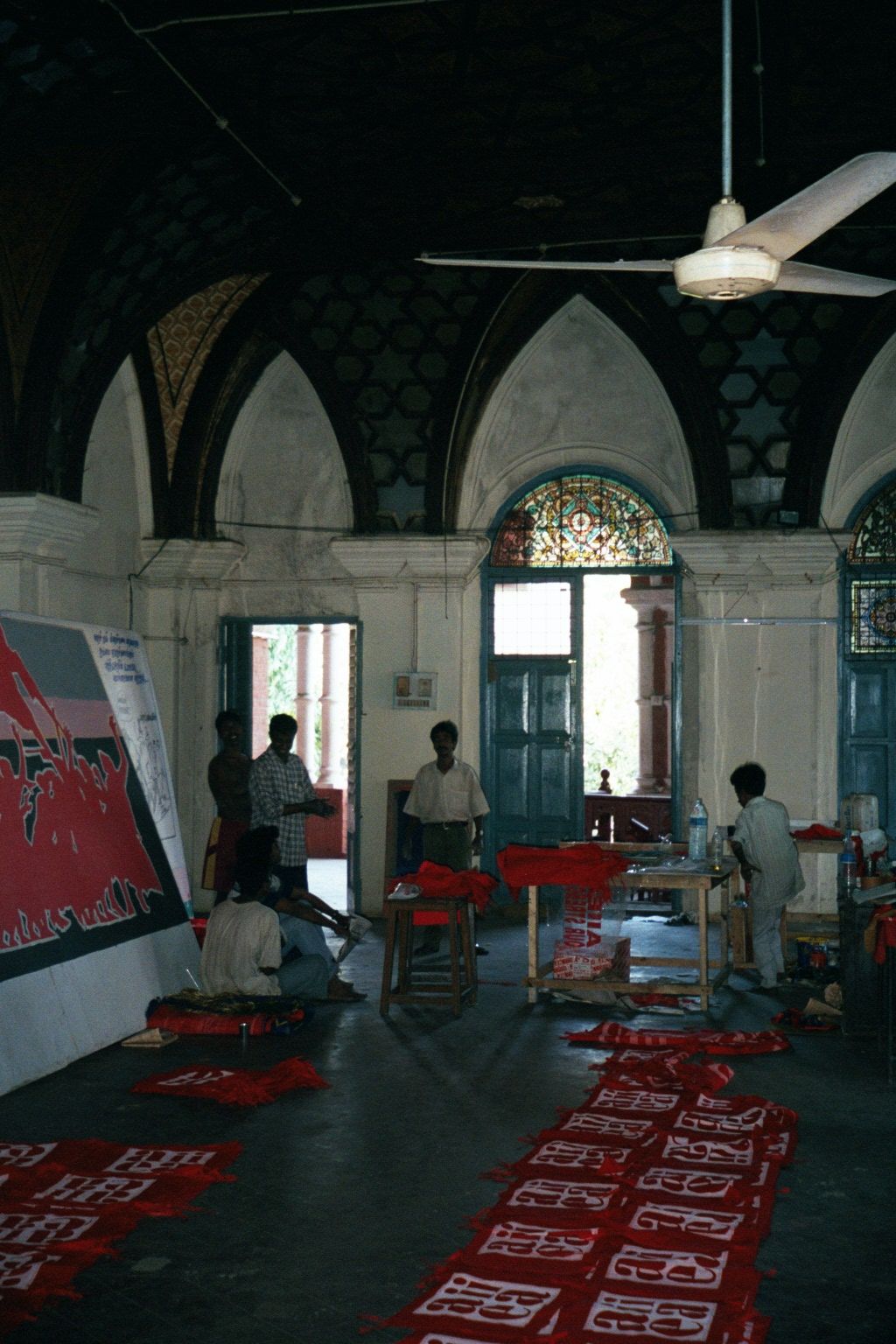 A crew is still at work, preparing posters.