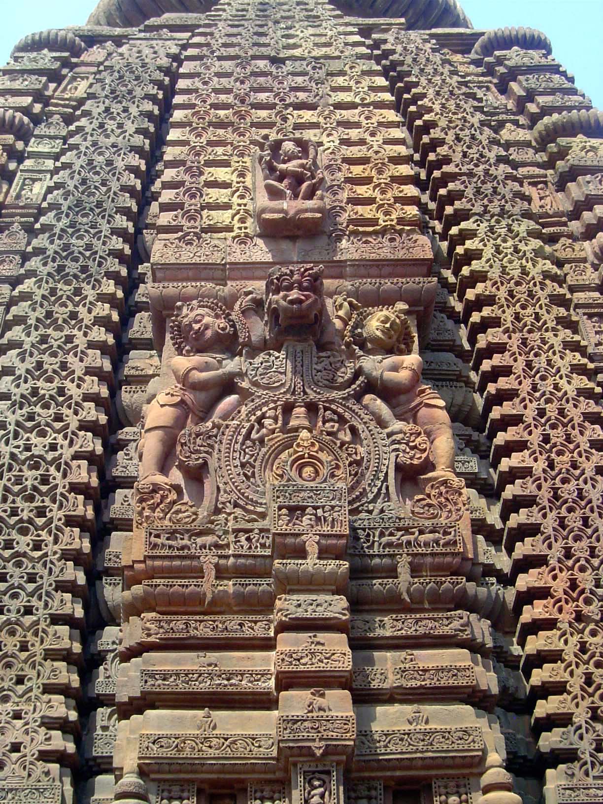 Guards protect the deity peering from the tiny window.