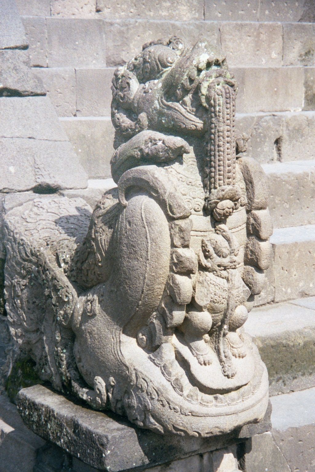 Makaras border the stairs and disgorge a lion that disgorges garlands.