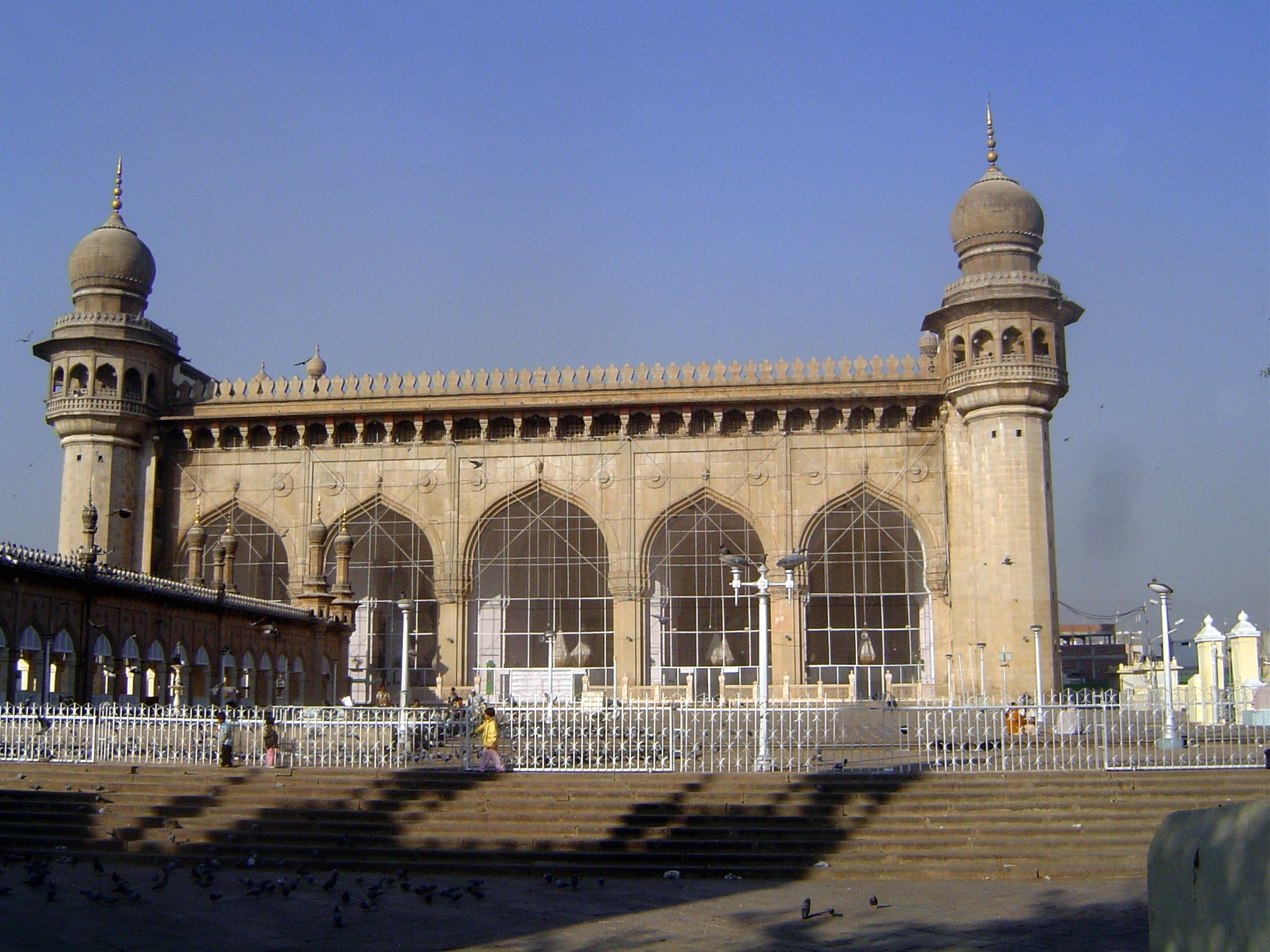 At ground level, looking across the large courtyard in front of the mosque. The structure on the left covers the tombs of Hyderabad's nizams