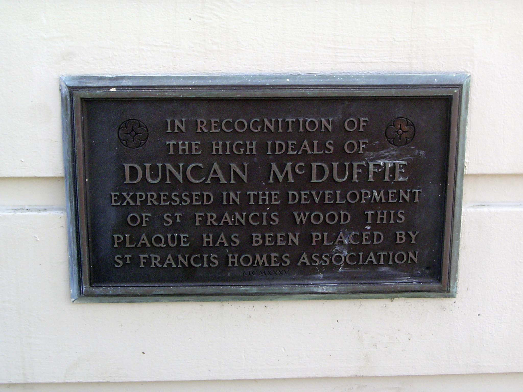 An undated plaque recalls the neighborhood's chief founder, whose name also lingers in the name of the realty company called Mason-McDuffie.