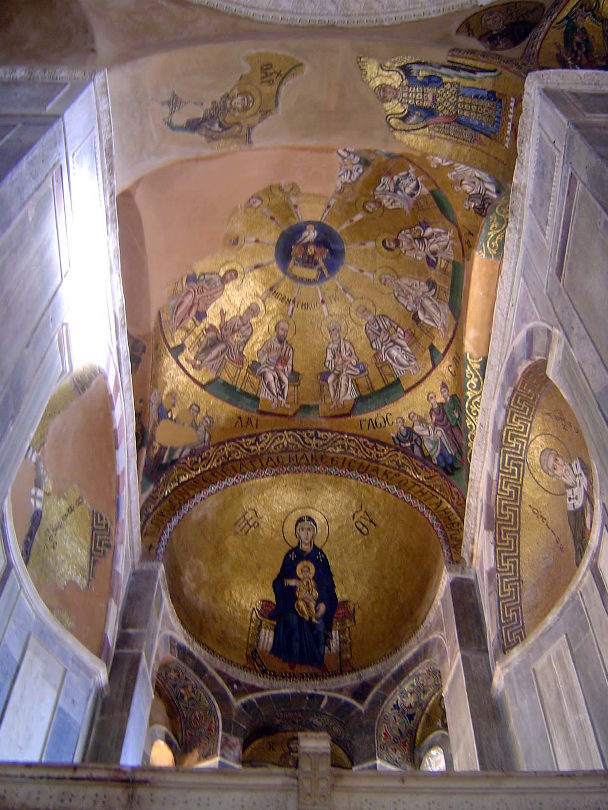Above the sanctuary, the virgin is enthroned; still higher, a circle of the pentecost.