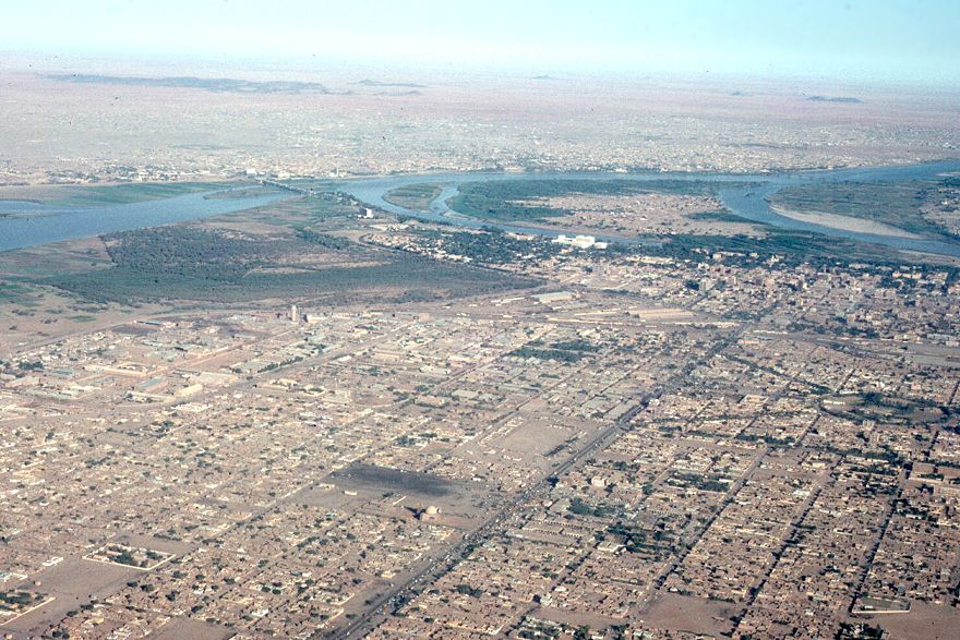 Omdurman lies in the distance and can be reached by the cantilever bridge visible crossing the White Nile just above the confluence with the