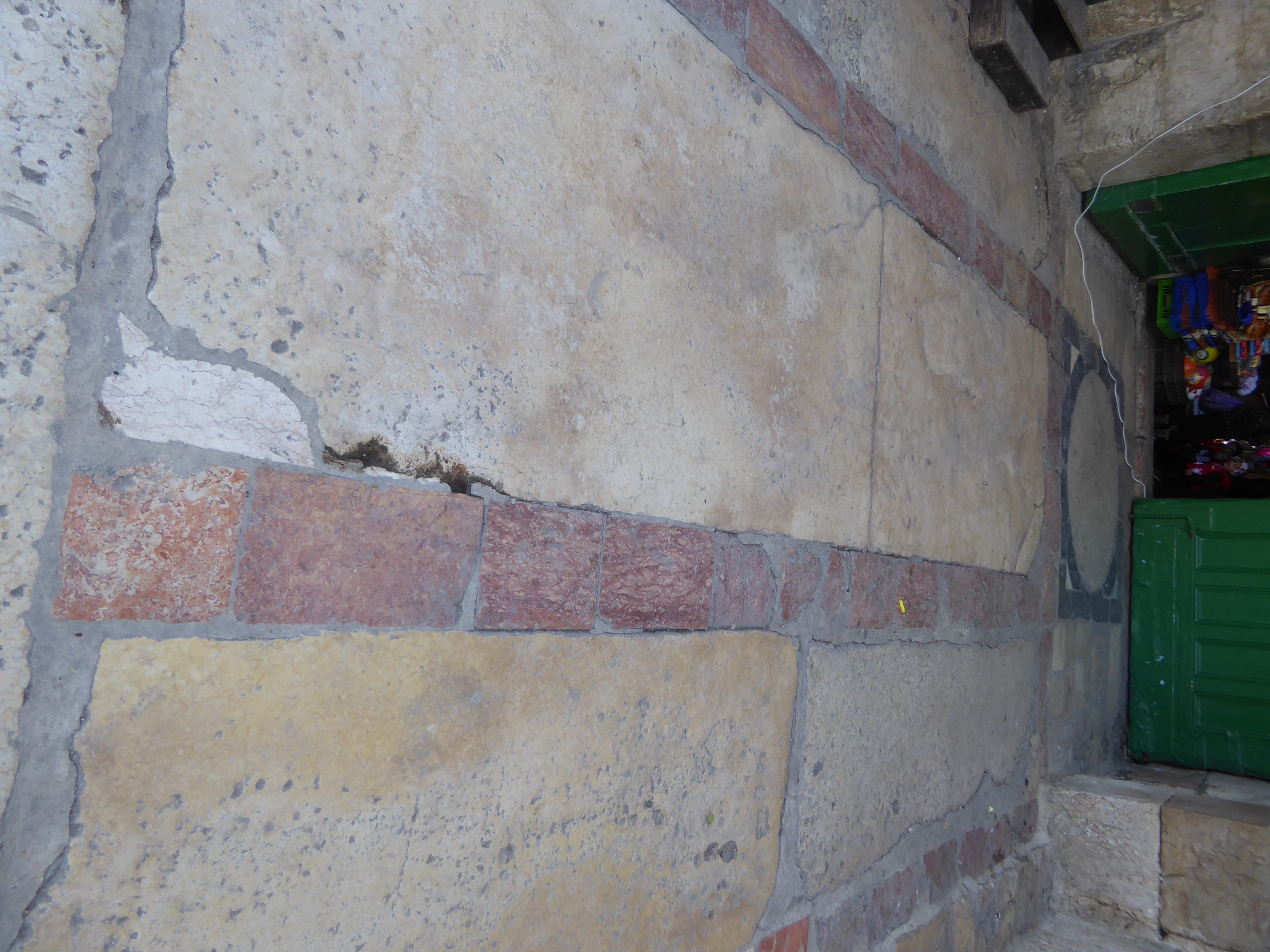 Neatly inlaid limestone in red, black, and yellow.