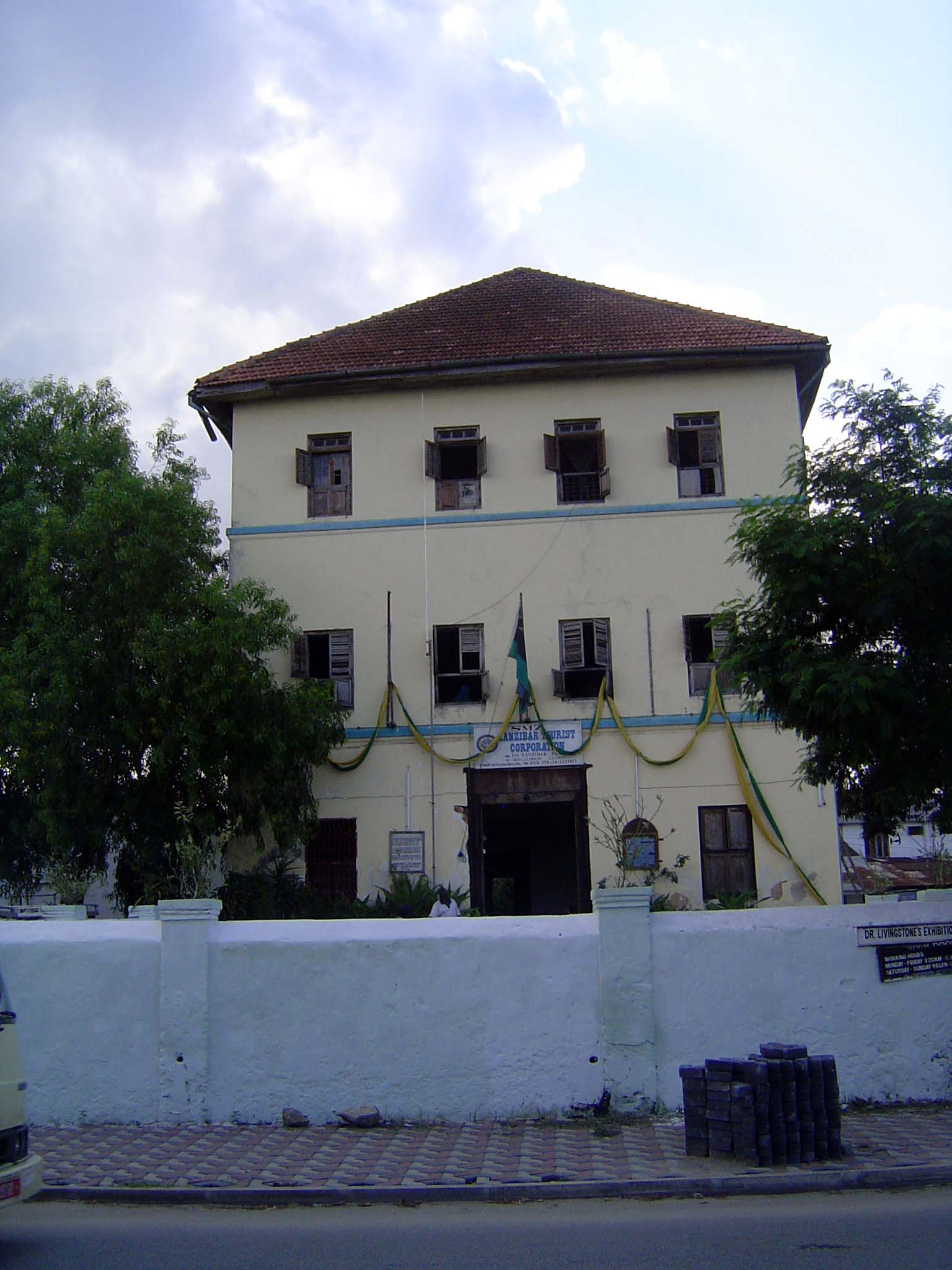 The sign over the door reads Zanzibar Tourist Corporation, but, as the smaller sign on the wall states, the building was once the residence
