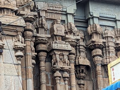 It's hard to see the deities portrayed on the tower but easy to see the stone work of the gopuram base.  It crams so many elements together