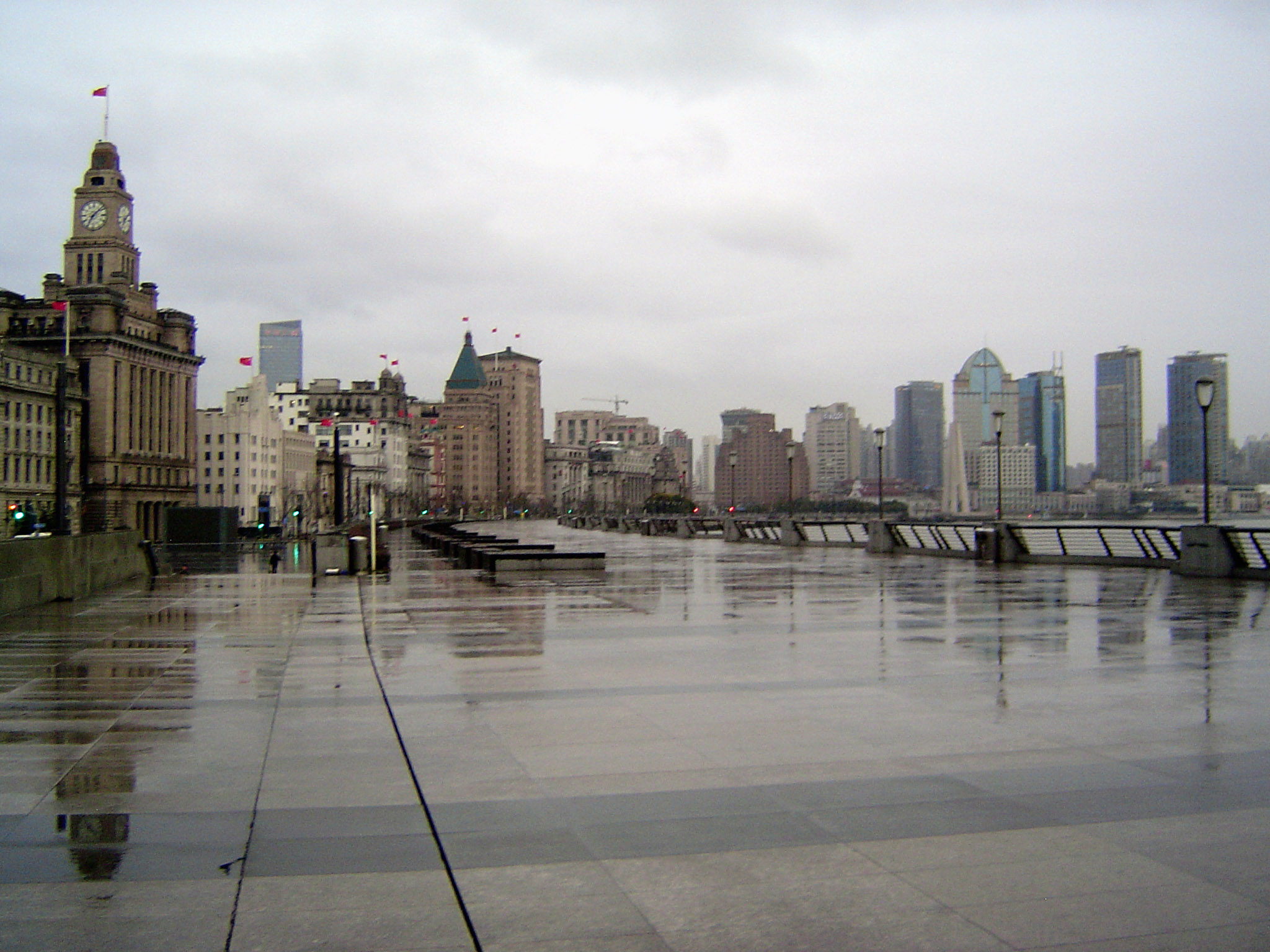 The view downstream and along the Bund, which must have one of the widest sidewalks in the world. Familiar faces: the Custom House, with the