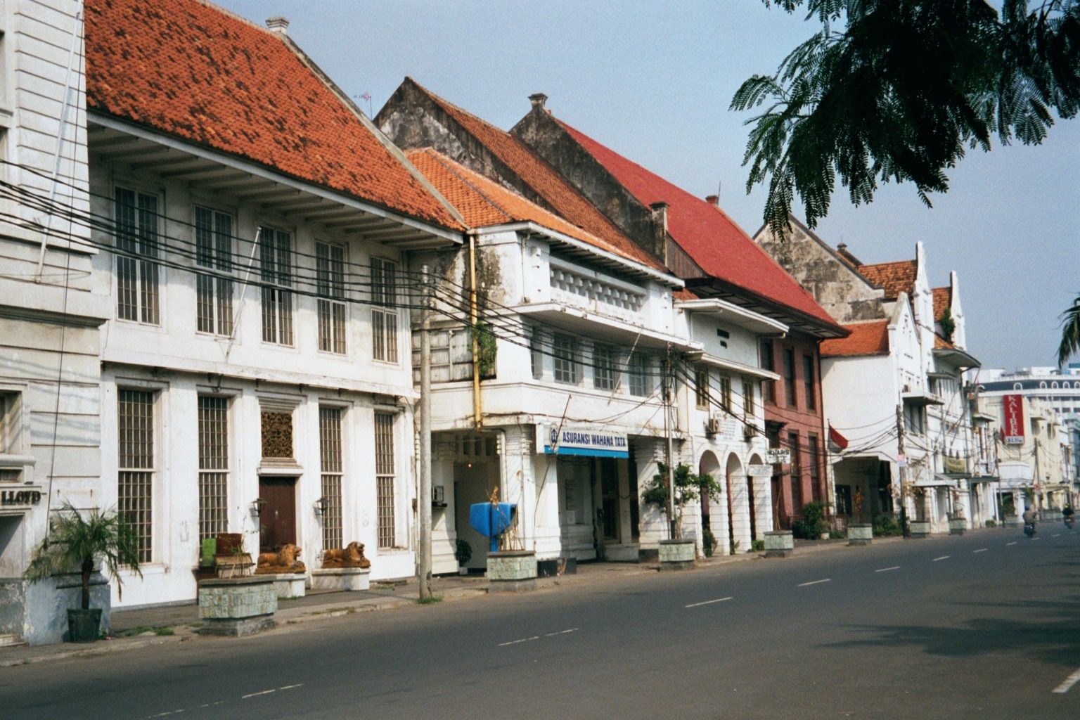 Some of the buildings have their gables parallel to the street; others, perpendicular to it. Note the red building midway down the street.