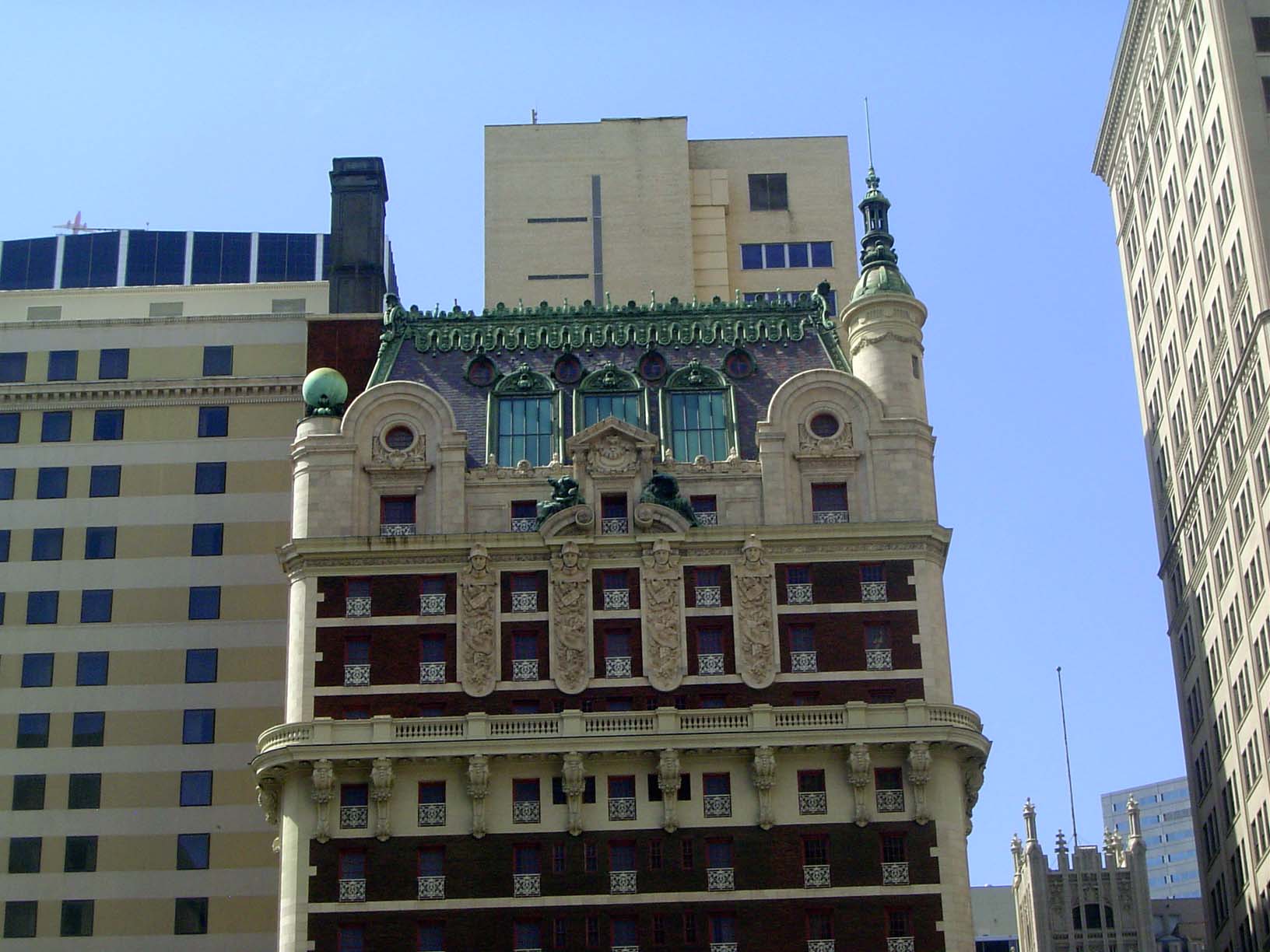 The hotel is still in business, though with far fewer rooms than in its heyday. The architectural trimming is in keeping with the overloaded