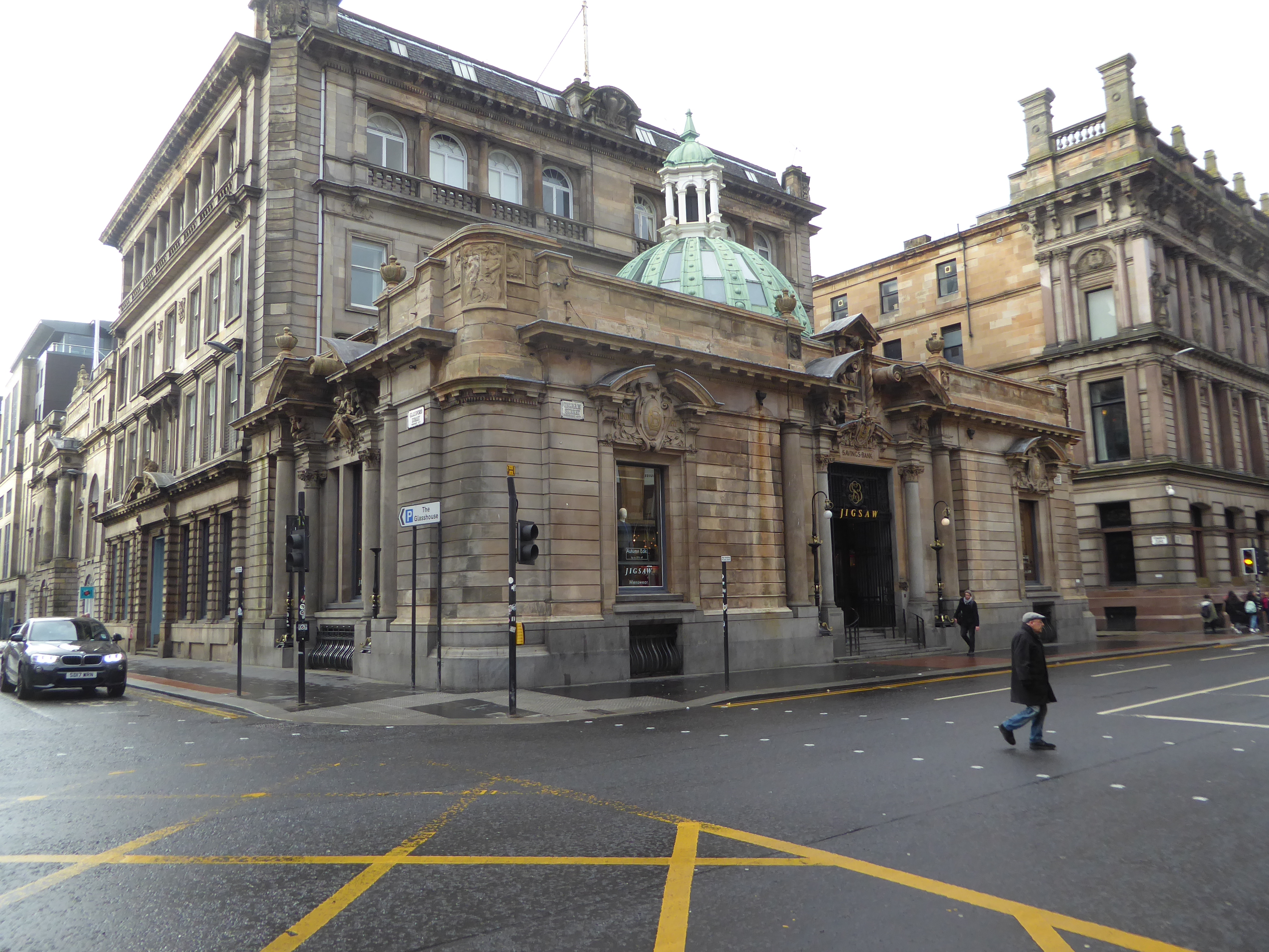 Here, on Ingram Street and about a block from George Square, is a menswear shop housed in an exotic banking hall from 1900. The hall was des
