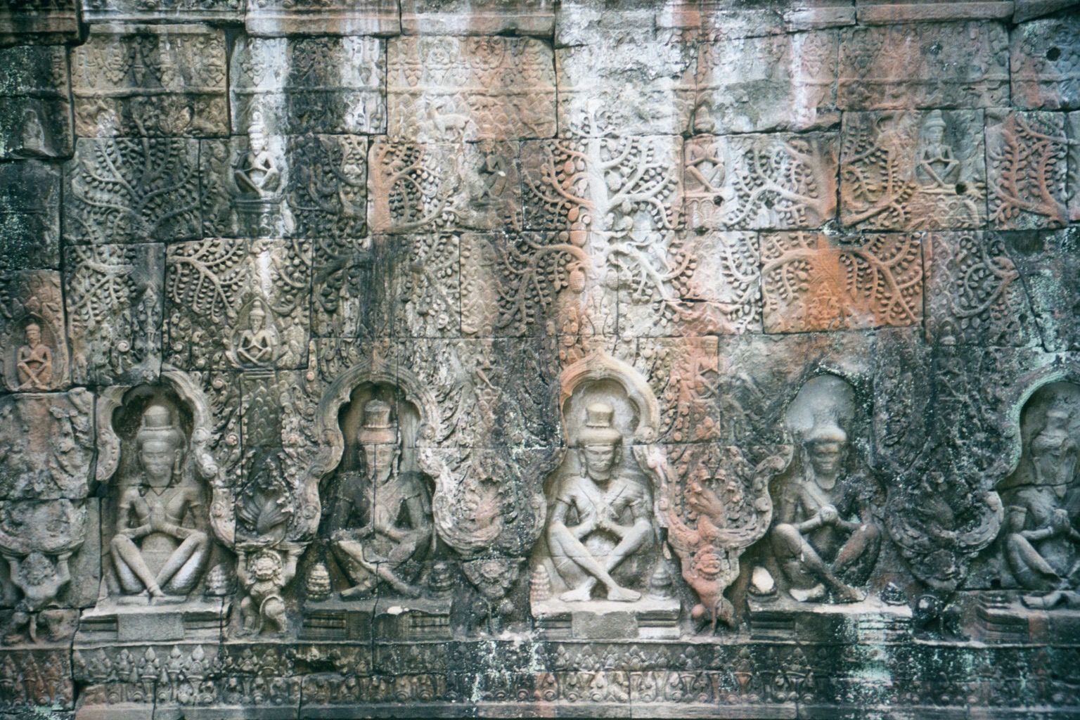 A nearby line of Buddhas was recarved during the Hindu interregnum into a line of prayerful hermits or rishis.