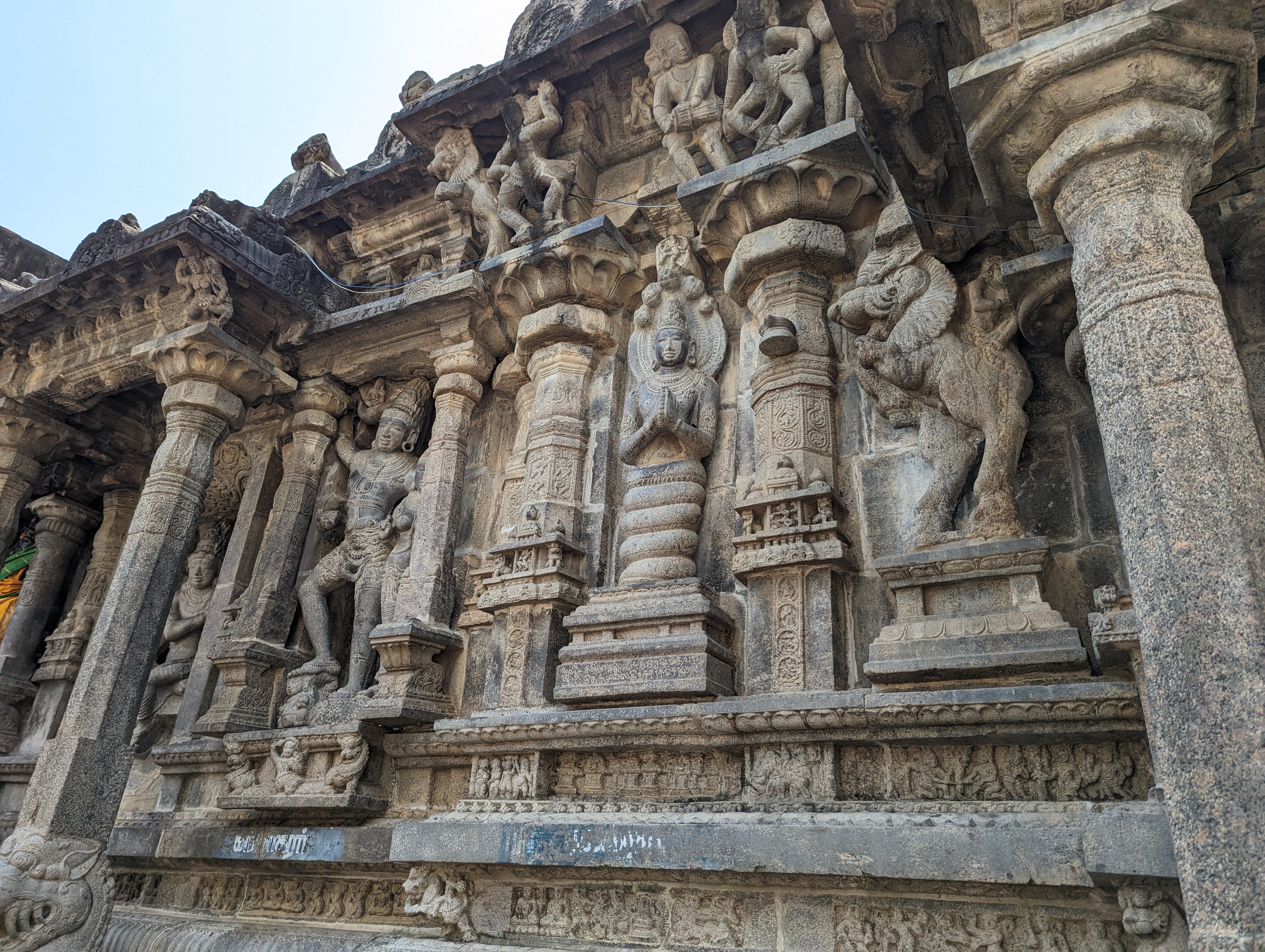 Busy, busy.  At the center, Manasa, the ancient and originally tribal snake goddess.  On the left, conceivably Siva as Kalasamharamurti, ste