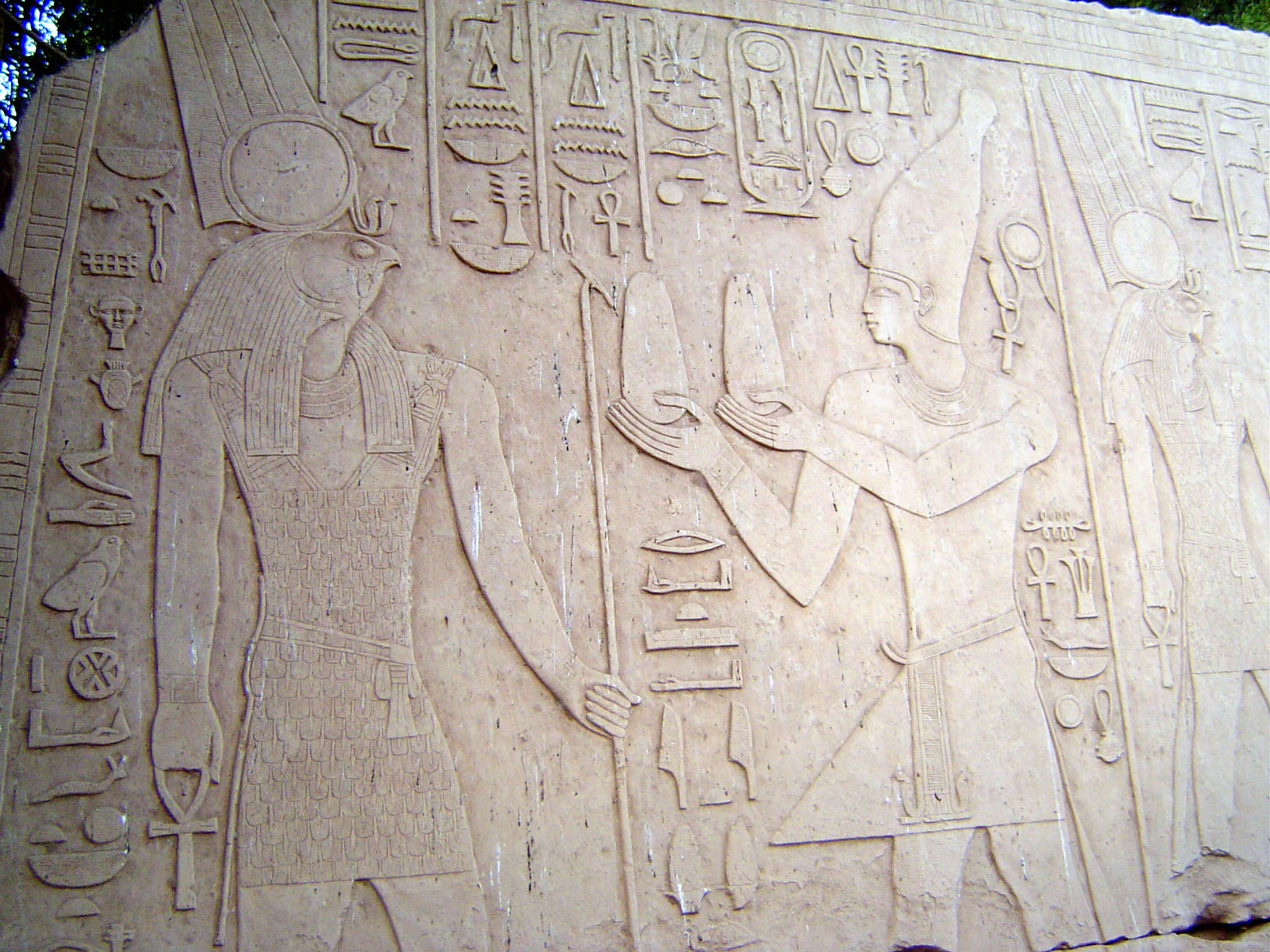 Still another: Alexander the Great offers bread to Montu, the Lord of Thebes, distinguished by the solar disk and twin plumes.