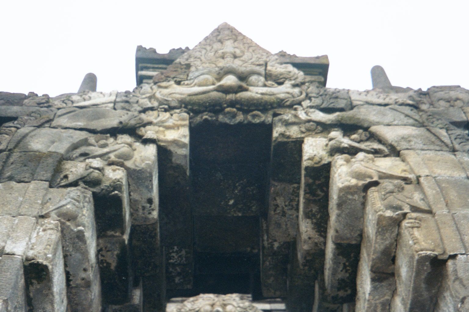 Climbing the stairs, you walk into the mouths of kala, a jawless creature associated with immortality. For other depictions, see Cambodia: A