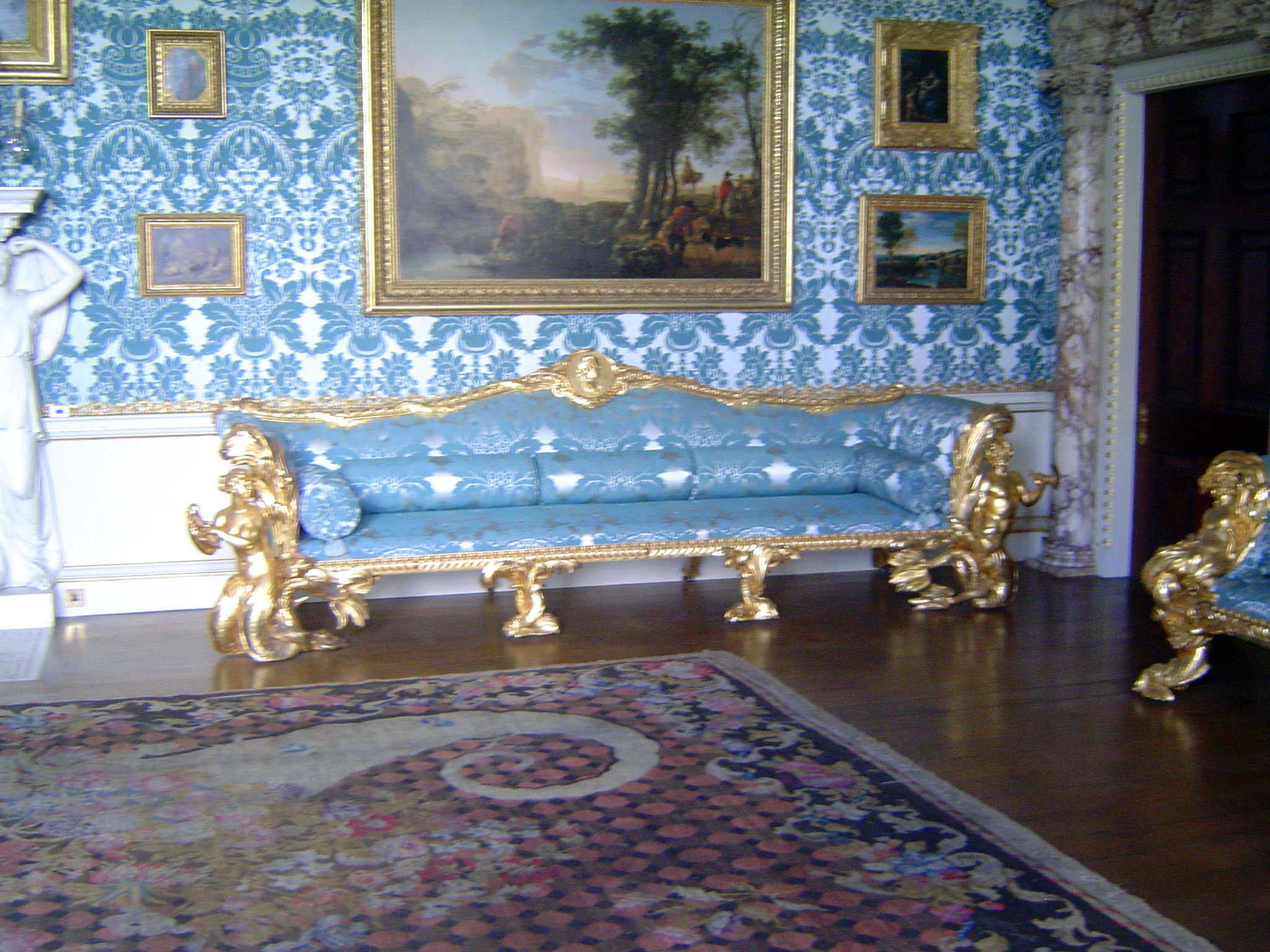 Gilding is the order of the day. The sofas were designed by Adam and have dolphin feet and merfolk supports.