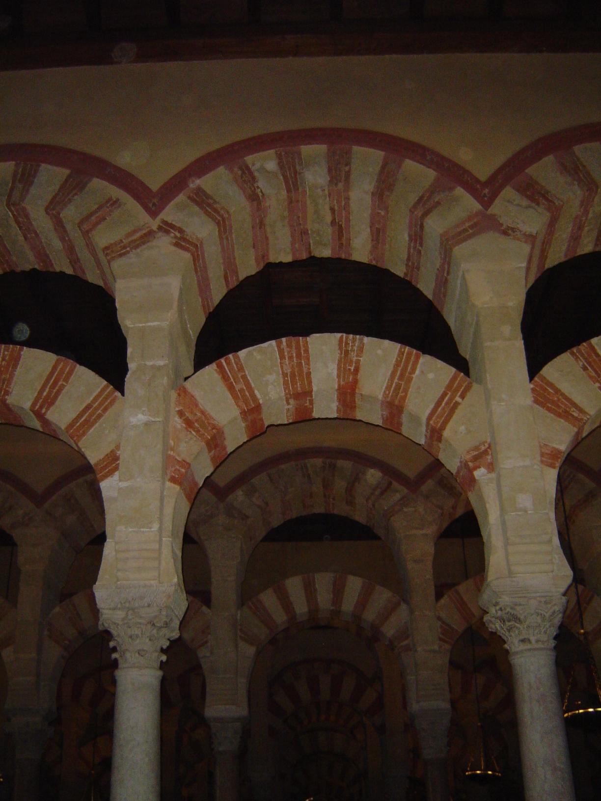 The columns support double-decked arches—the upper circular, the lower slightly horseshoe-shaped. It's a design adapted from Roman aqueducts