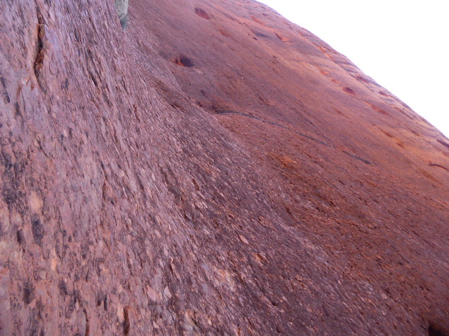 Come up and pat the stone. You'll be surprised if you expect a coarse sandstone easily scraped by a key. This stuff is hard.