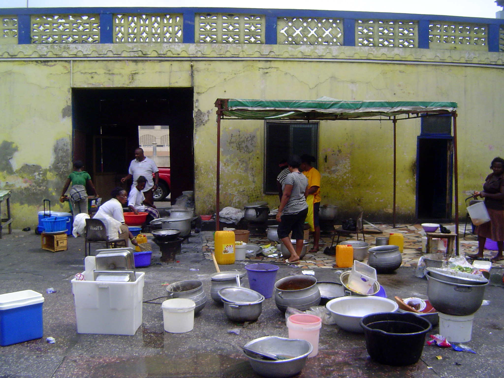 Inside, the rooms are closed and the courtyard is used to prepare food sent out. A remote kichen, in other words.