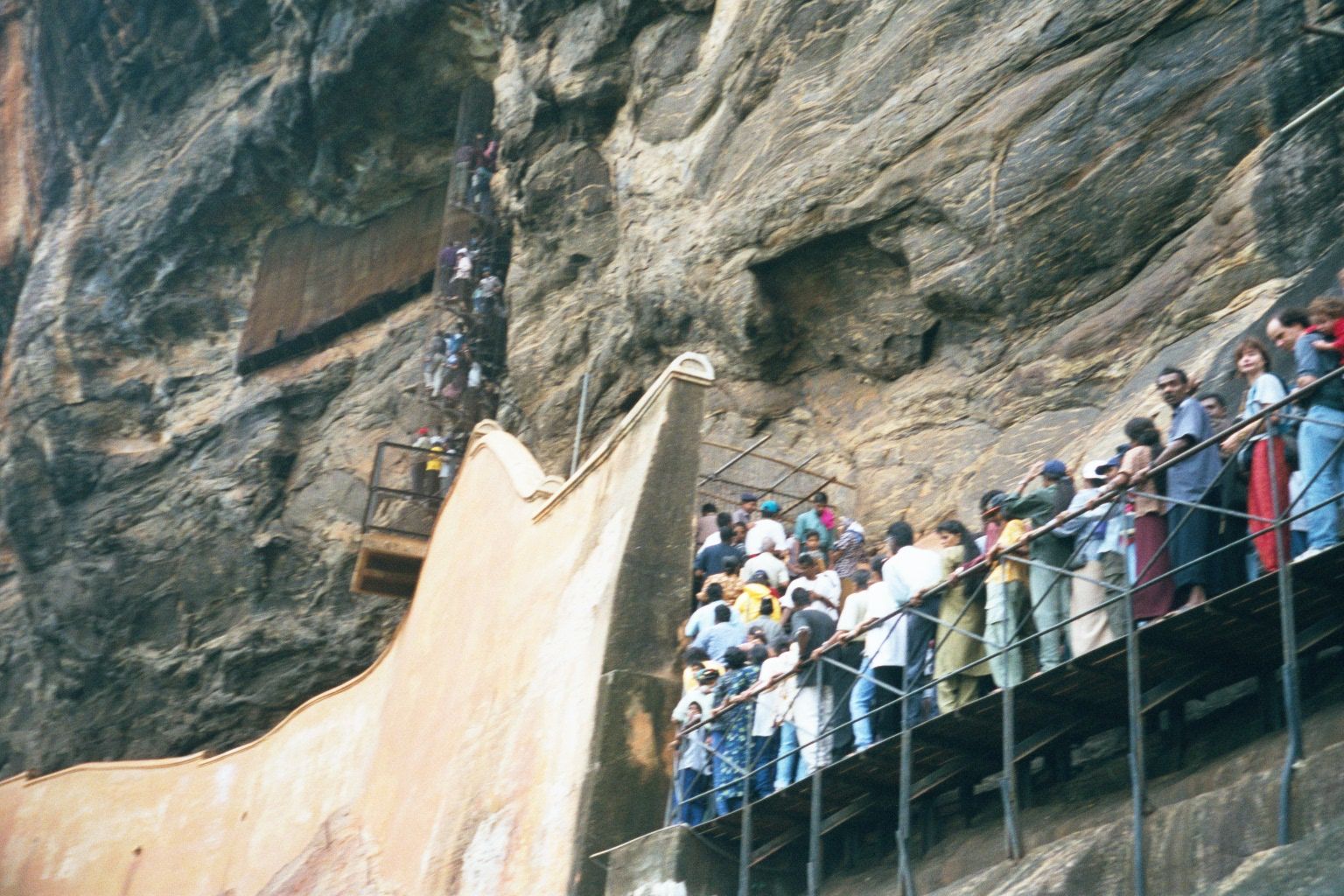 The wall is an ancient one, supplemented by the modern catwalk and the spiral staircase, which deadends against a wall of frescoes.