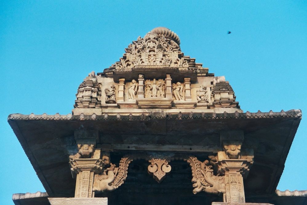 This is the entrance to the Lakshmana vestibule, showing the temple's pyramidal roof the jagamohan or phamsana and a pair of flamboyant maka