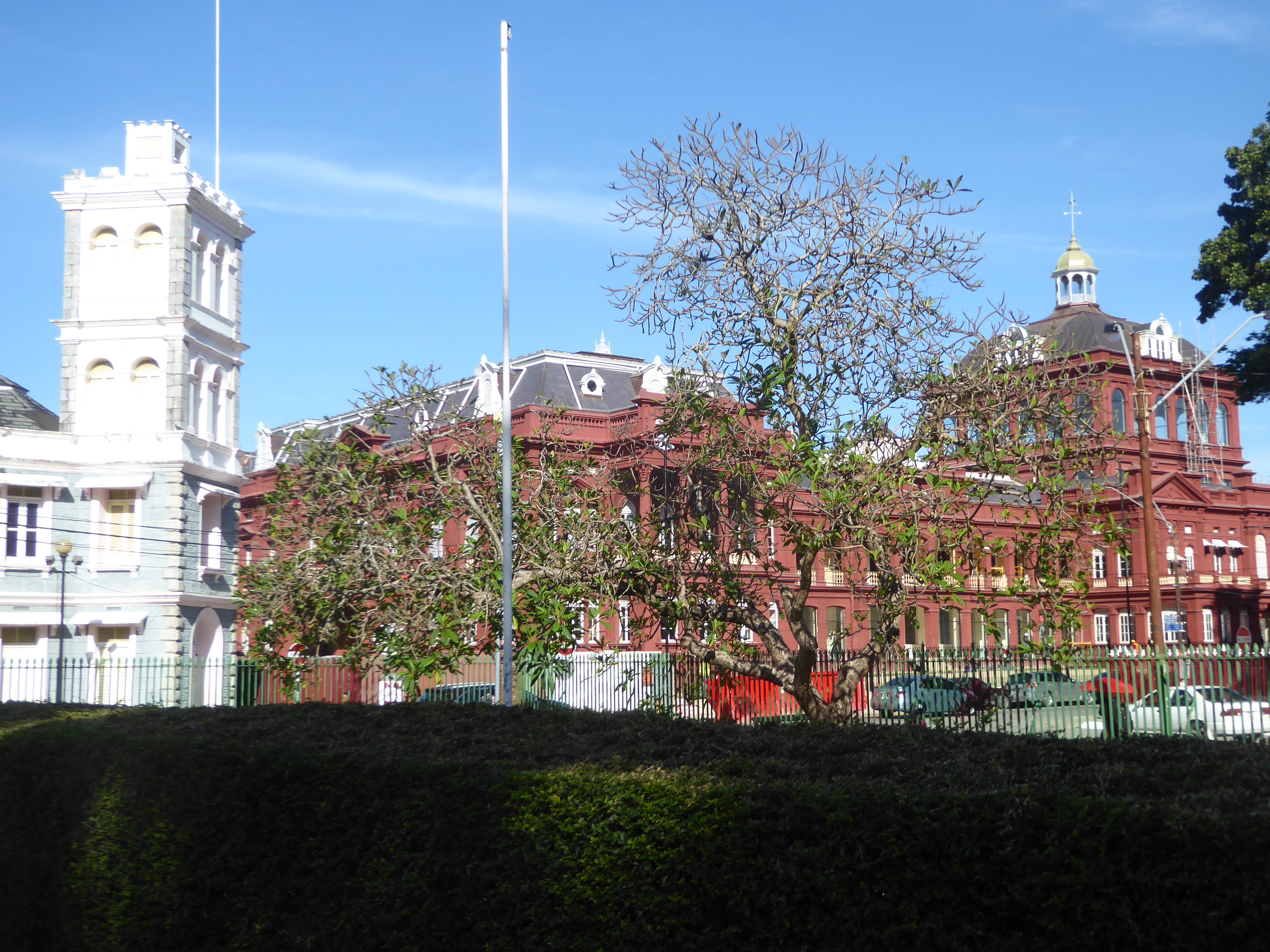 The view diagonally from the cathedral grounds to the old fire station and the Red House, now the seat of Trinidad's parliament. It faces Wo