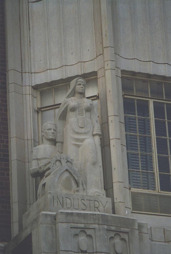 Adams Hall detail: Dame Industry, with Roboman well-behaved at her elbow. She wears a nun's habit but has the belly-plating of an space-warr