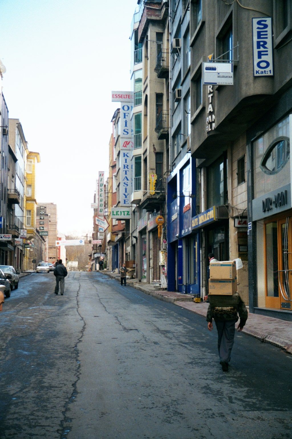 Eminonu itself is an intensely crowded district, despite the impression given in this picture. The porter is bent under a load of boxes. The