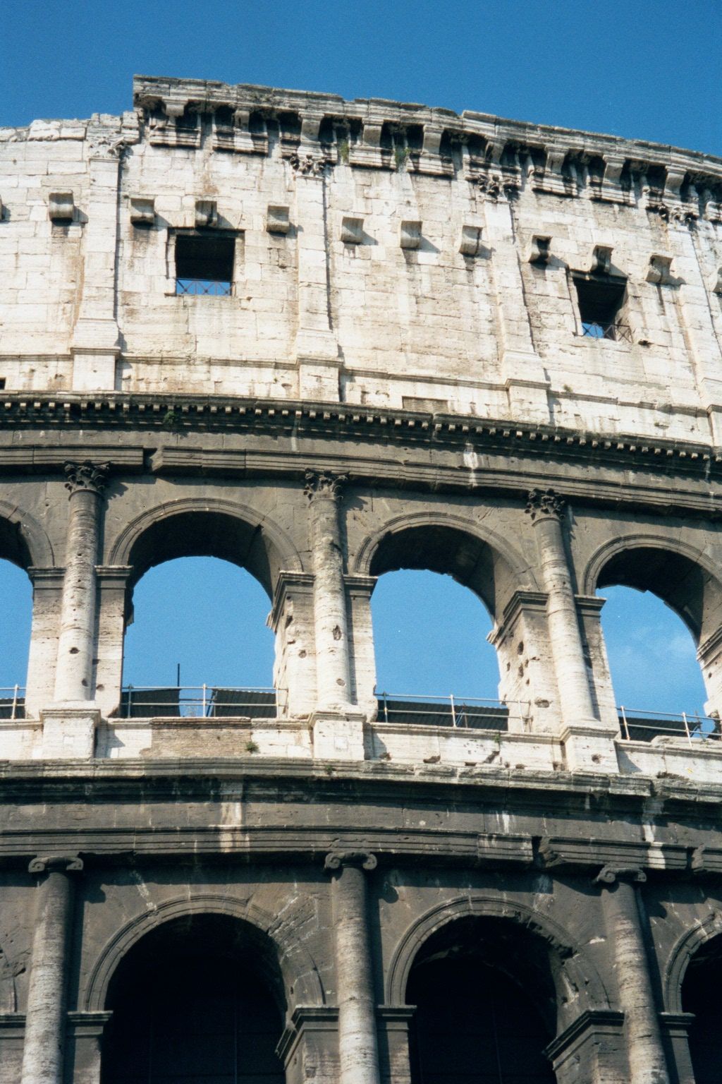 The corbels up top provided a base and brace for vertical masts from which ropes were suspended across the vast arena. Those ropes supported