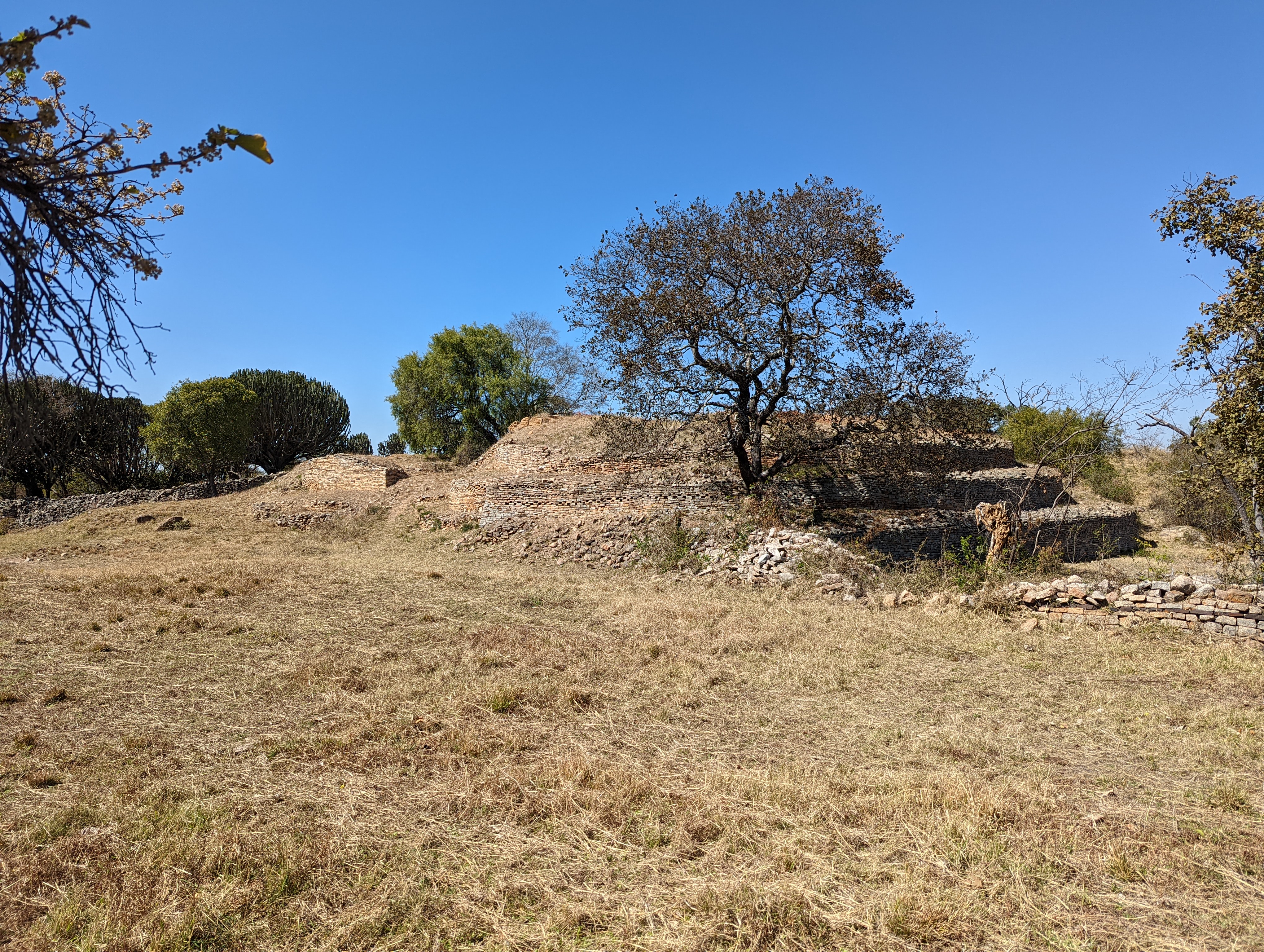 The big man's entrance was there on the left, near the sharp corner in shade.