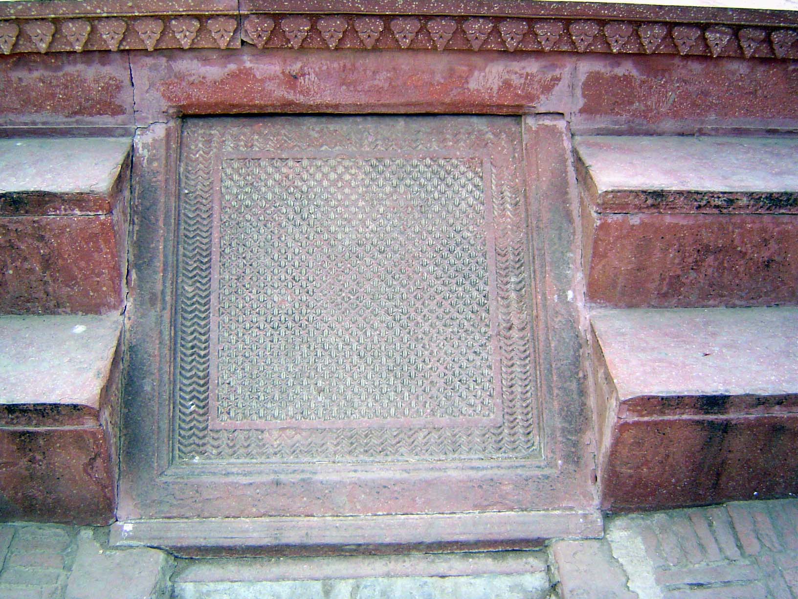 Water once babbled over this sloping stone. For a glimpse of what it looked like, see the rainy-day pictures of Akbar's tomb at Sikandra, ne
