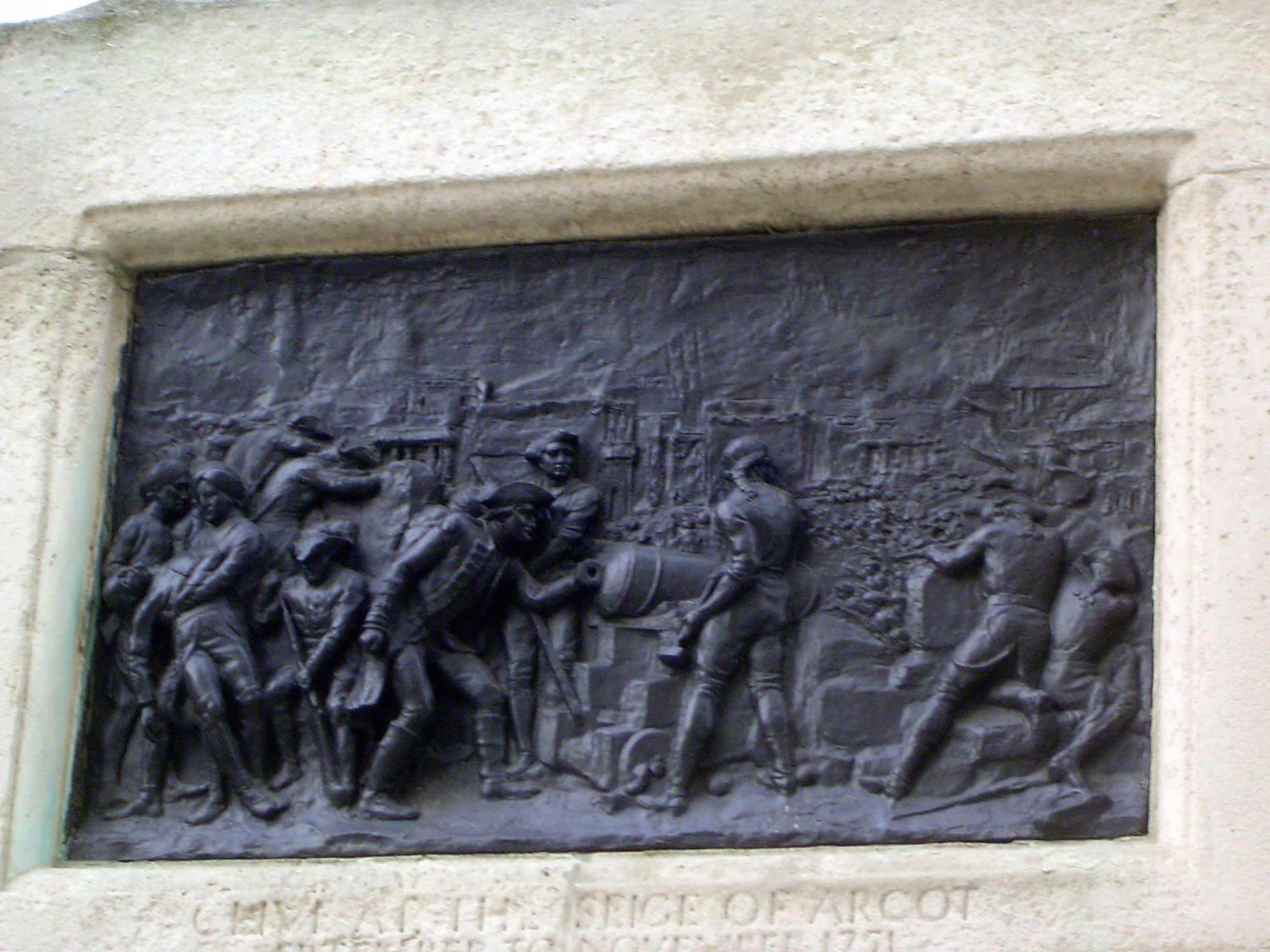 His career is illustrated at the base of the monument. An early triumph: "At the siege of Arcot."