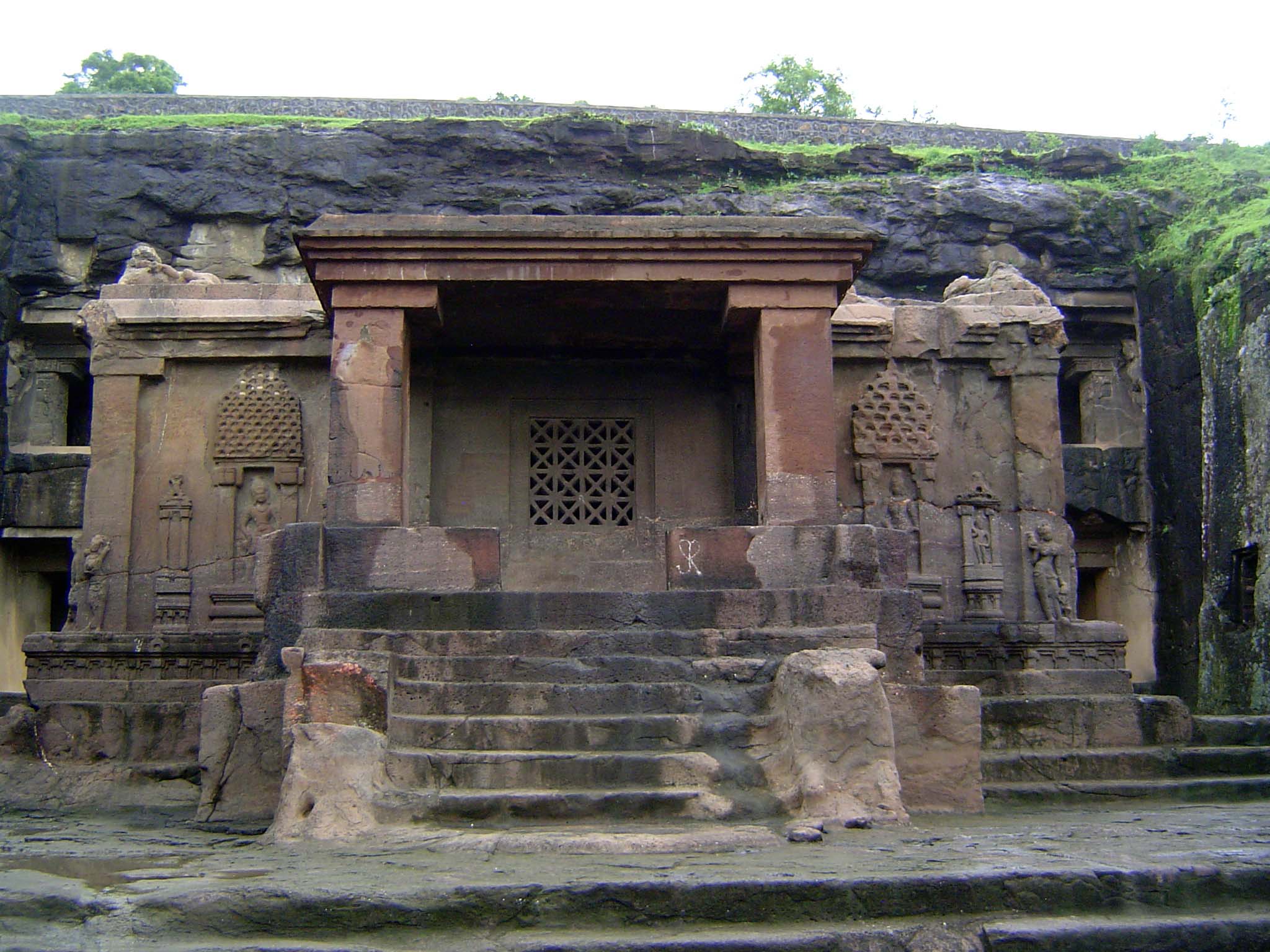 We're going to take quick look at some neighboring caves, neither as spectacular as Kailash but with expressive sculpture. Here, the entranc