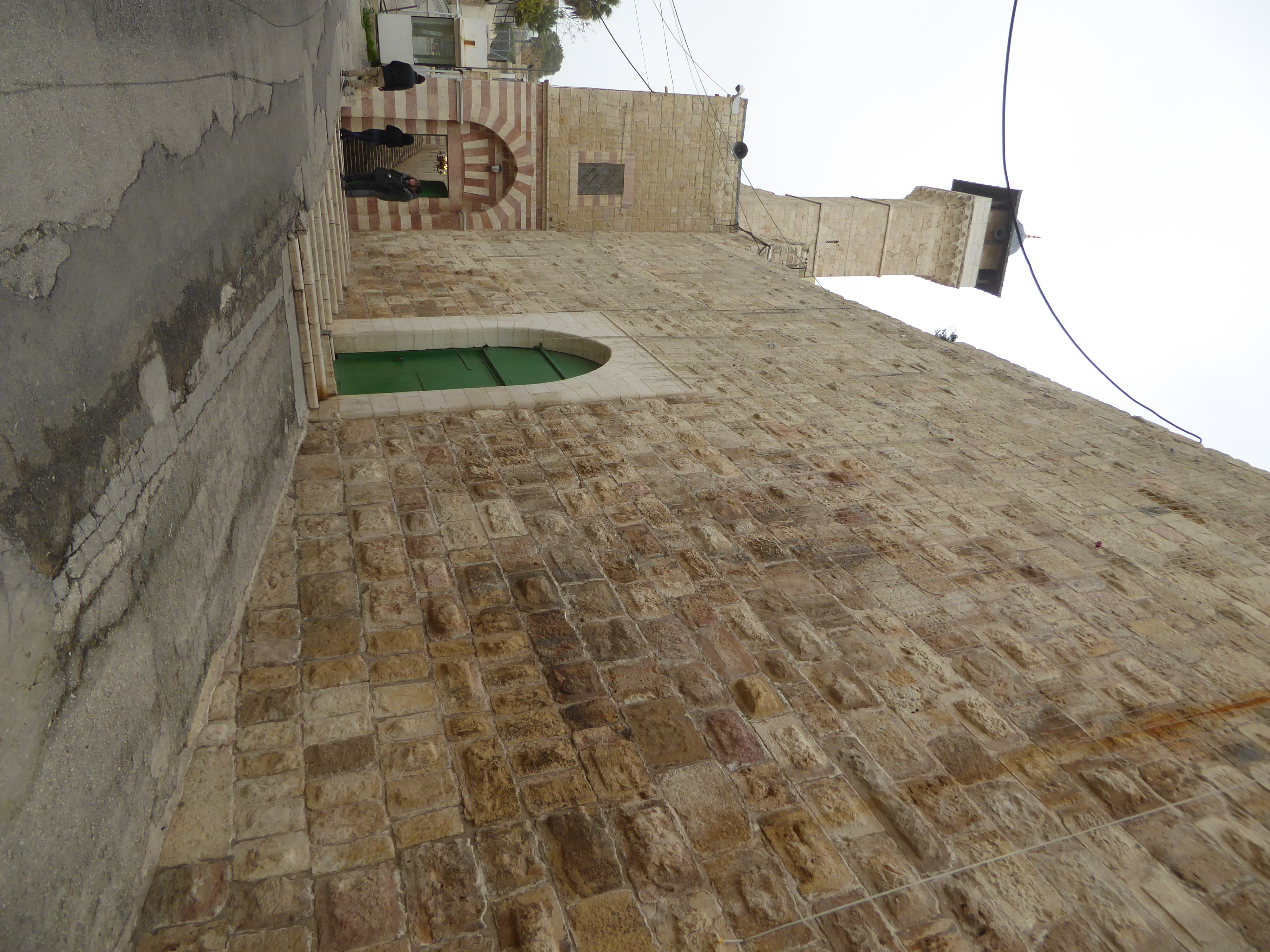 The entrance to the mosque inside the enclosure is through these steps that hug the wall.