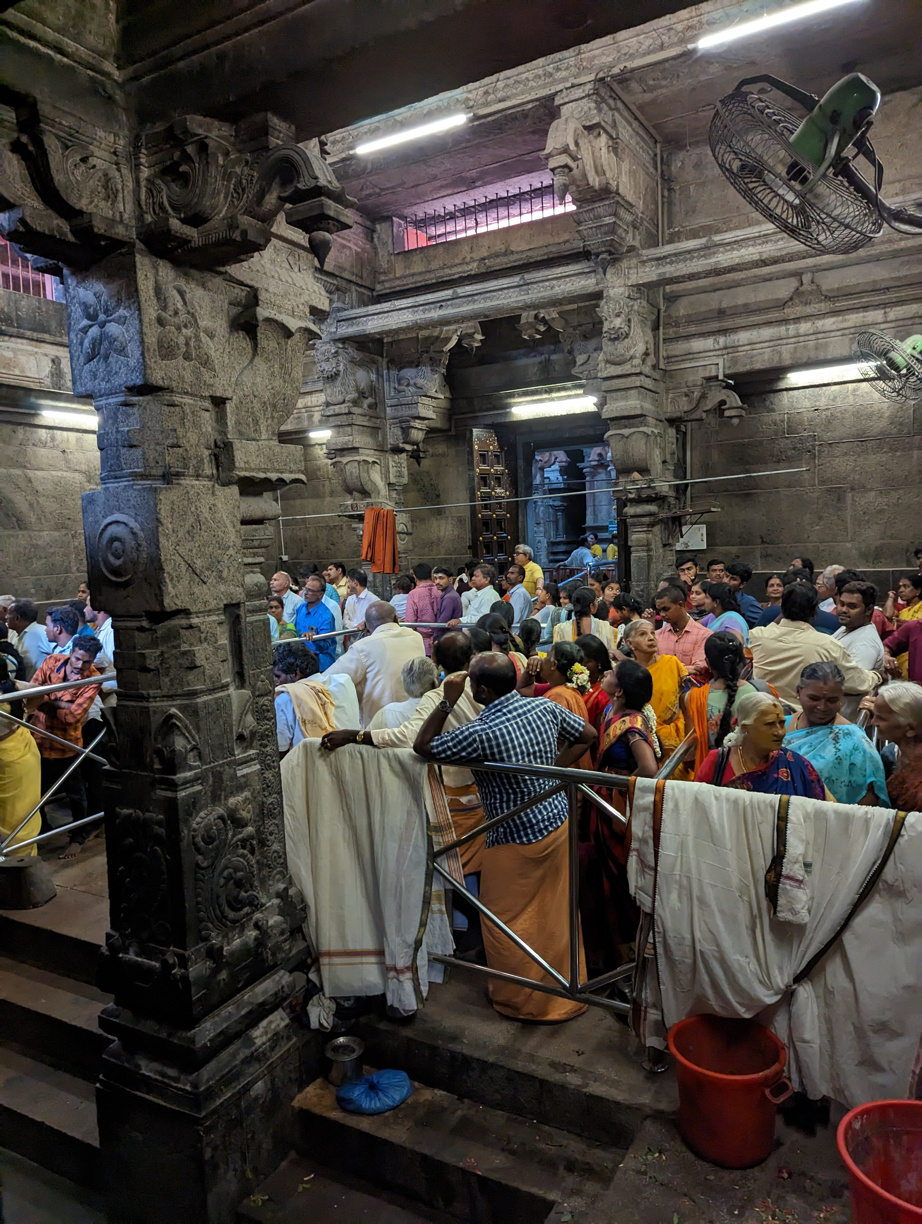 We're in the anteroom to the temple shrine.  Not sure when the temple managers adopted zigzag or serpentine queueing--or where they got the