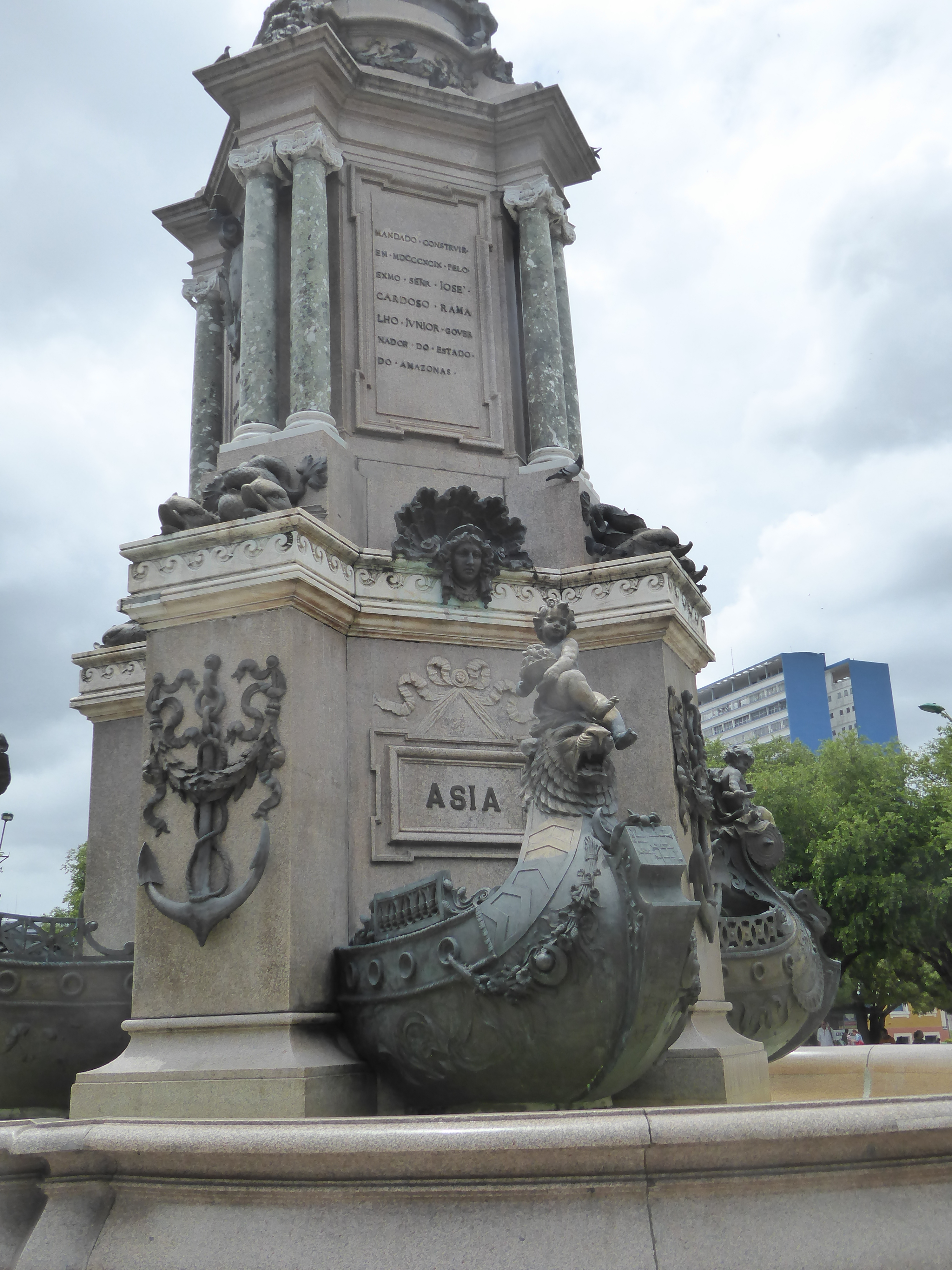 The cherub on Asia's boat sits on a lion and holds a bowl of...what? Fruit? Just below the lion there's an Islamic crescent. The plaque stat