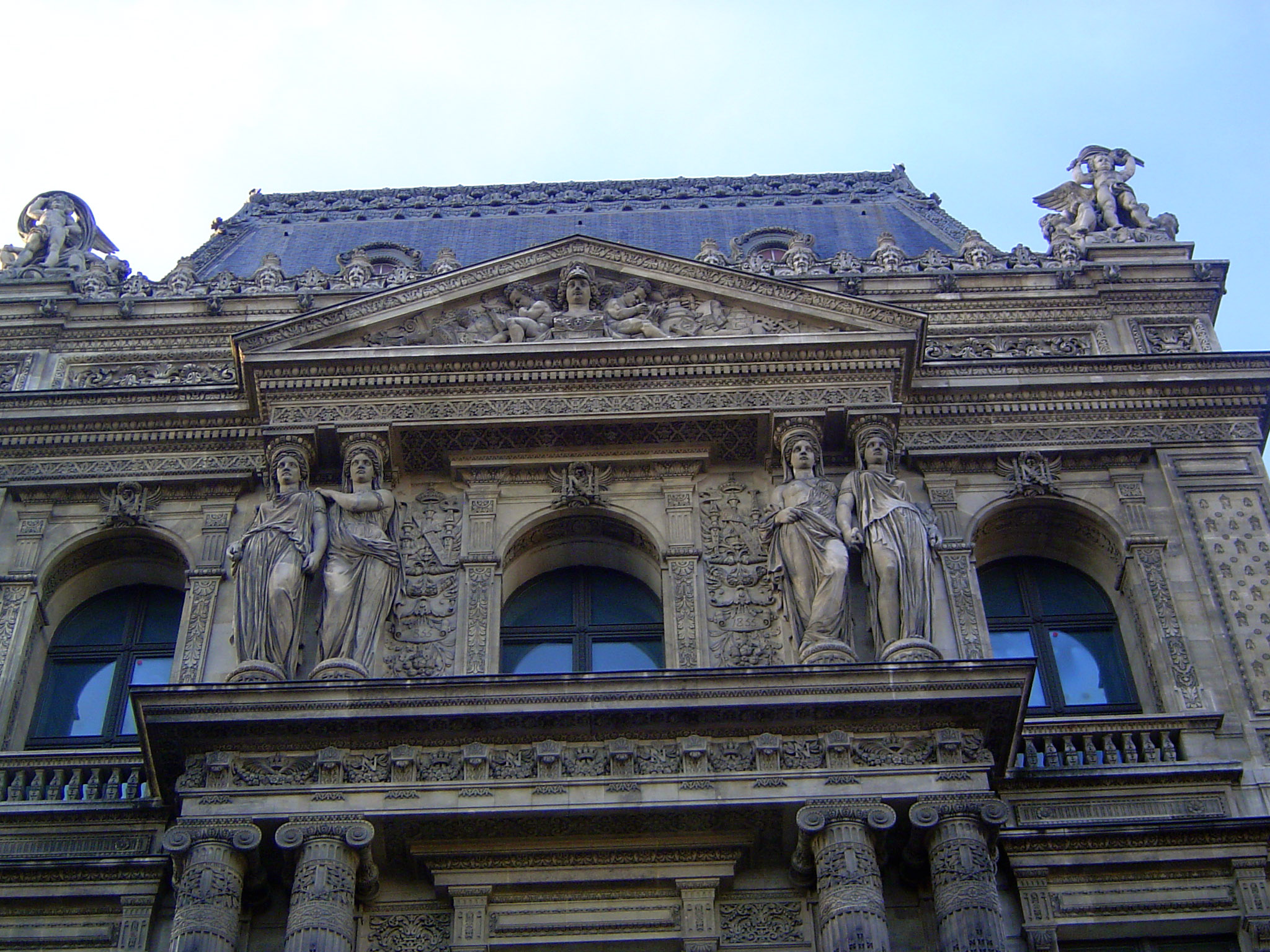 Lefuel created the pavilions seen in the Cour Napoleon. He kept Le Mercier's poor caryatids but "encrusted his facades with luxuriant sculpt