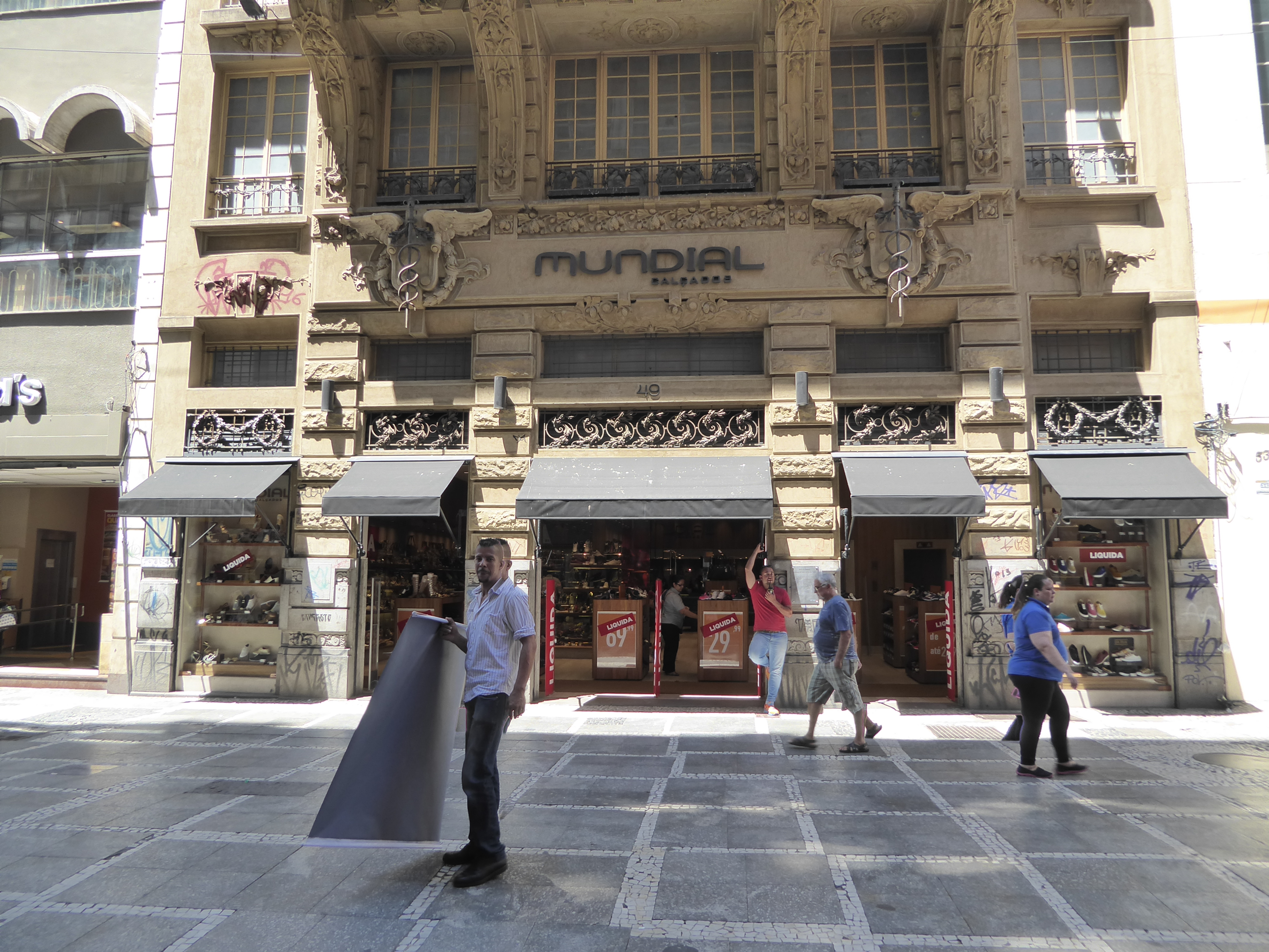 The facade of the older building remains loyal to the 19th century, though the original owner would probably be appalled to see a shoe store