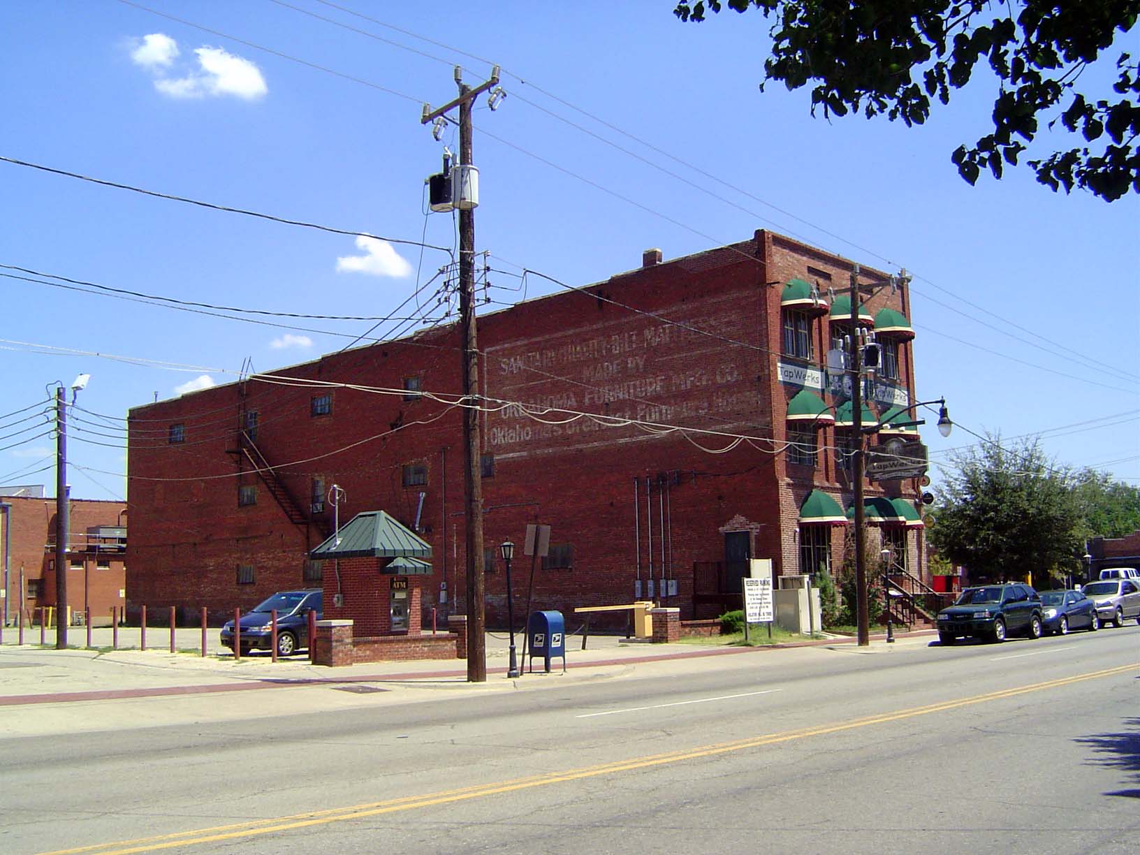 Some old factory buildings survive, too, including the Oklahoma Furniture Manufacturing Company, which was built in 1904. The green awnings