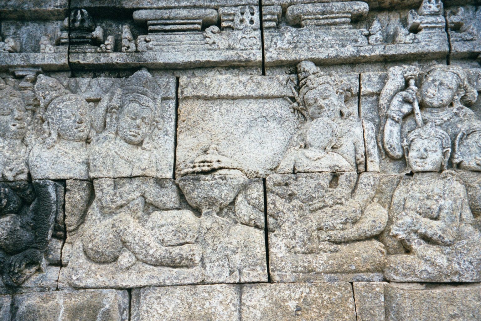 Wise men come to honor the child, shown in his father's lap.