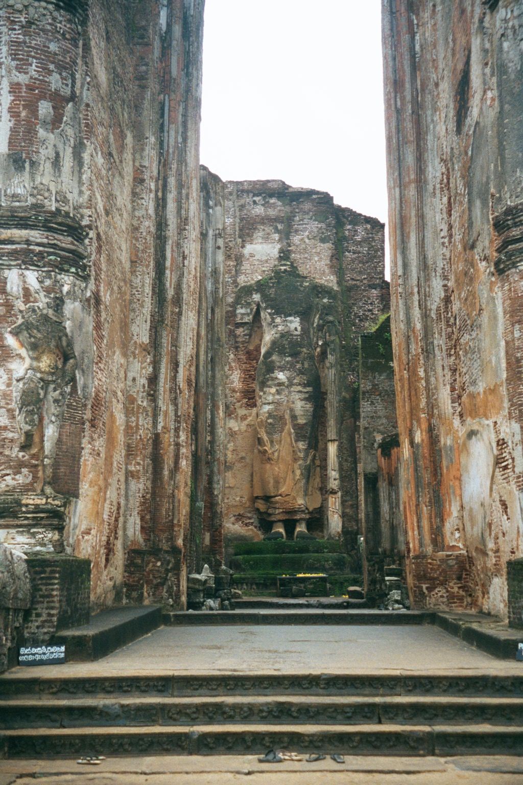 A decapitated statue of the Buddha. The building's name, Lankatilaka, means "beauty spot of Lanka." It was completed in 1270.